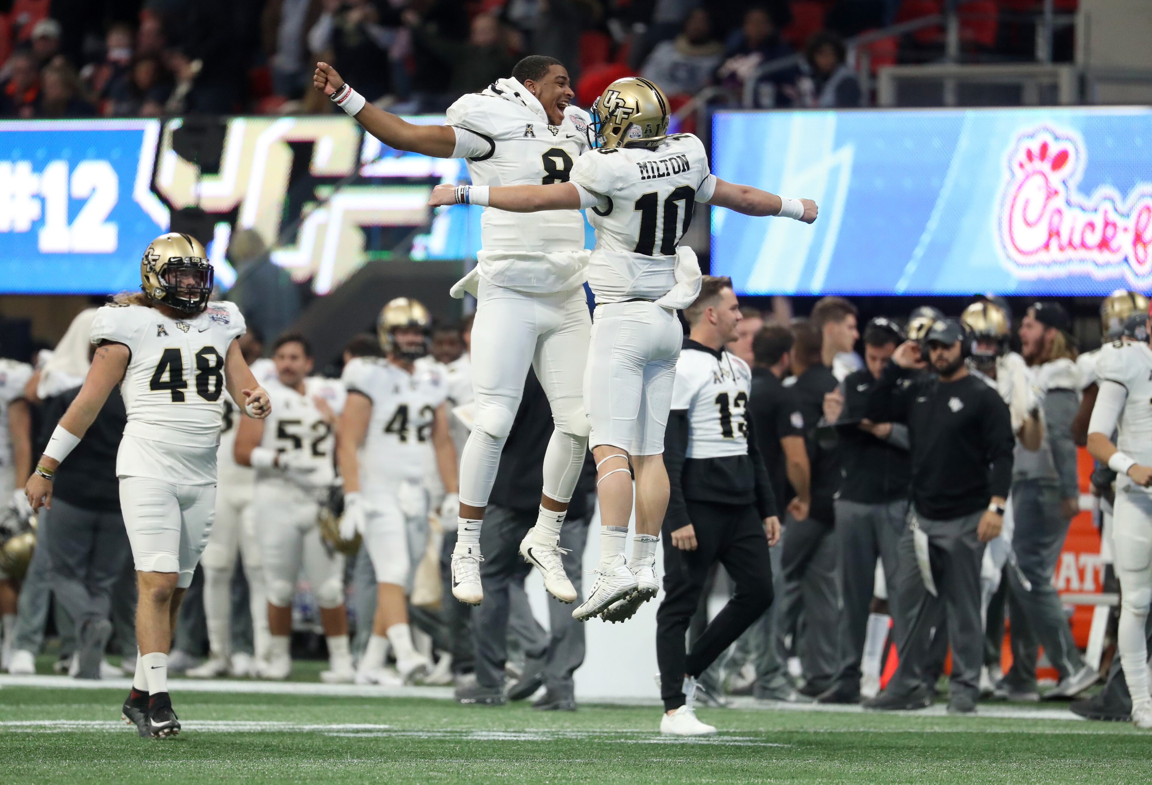 January 1, 2018 - Atlanta, Ga: UCF Knights quarterback McKenzie Milton (10) celebrates a touchdown pass with quarterback Darriel Mack Jr. (8) during the third quarter against the Auburn Tigers in the Chick-fil-a Peach Bowl at the Mercedes-Benz Stadium Monday, January 1, 2018, in Atlanta. The UCF Knights won 34-27. PHOTO / JASON GETZ