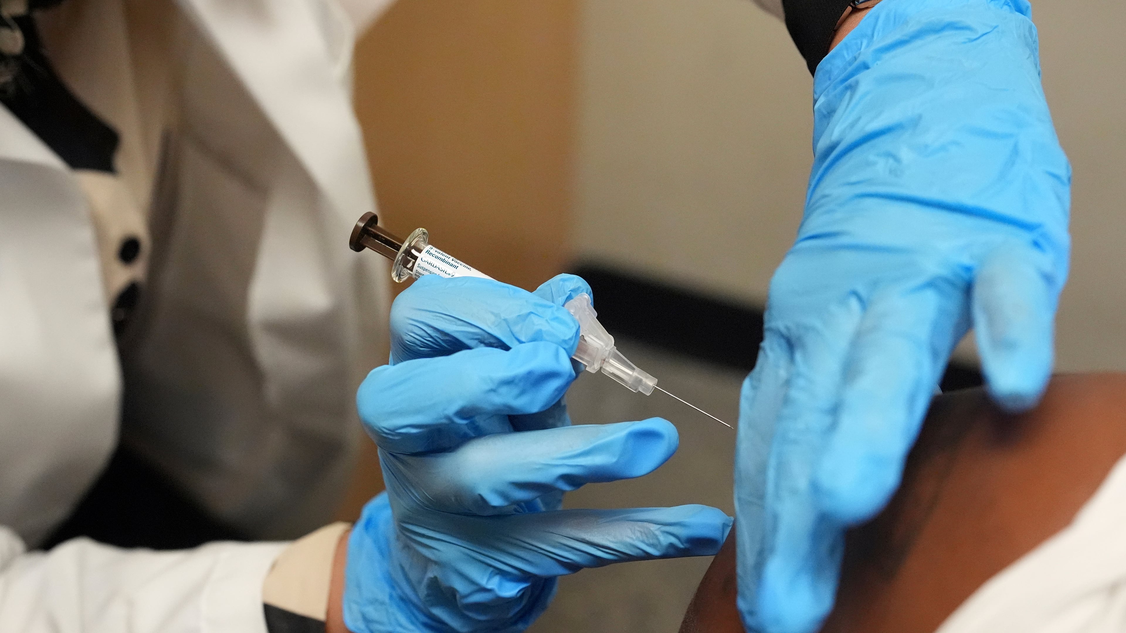 FILE - A patient receives a vaccine protecting against human papillomavirus (HPV) at a pharmacy in Miami, Sept. 9, 2025. (AP Photo/Rebecca Blackwell, File)