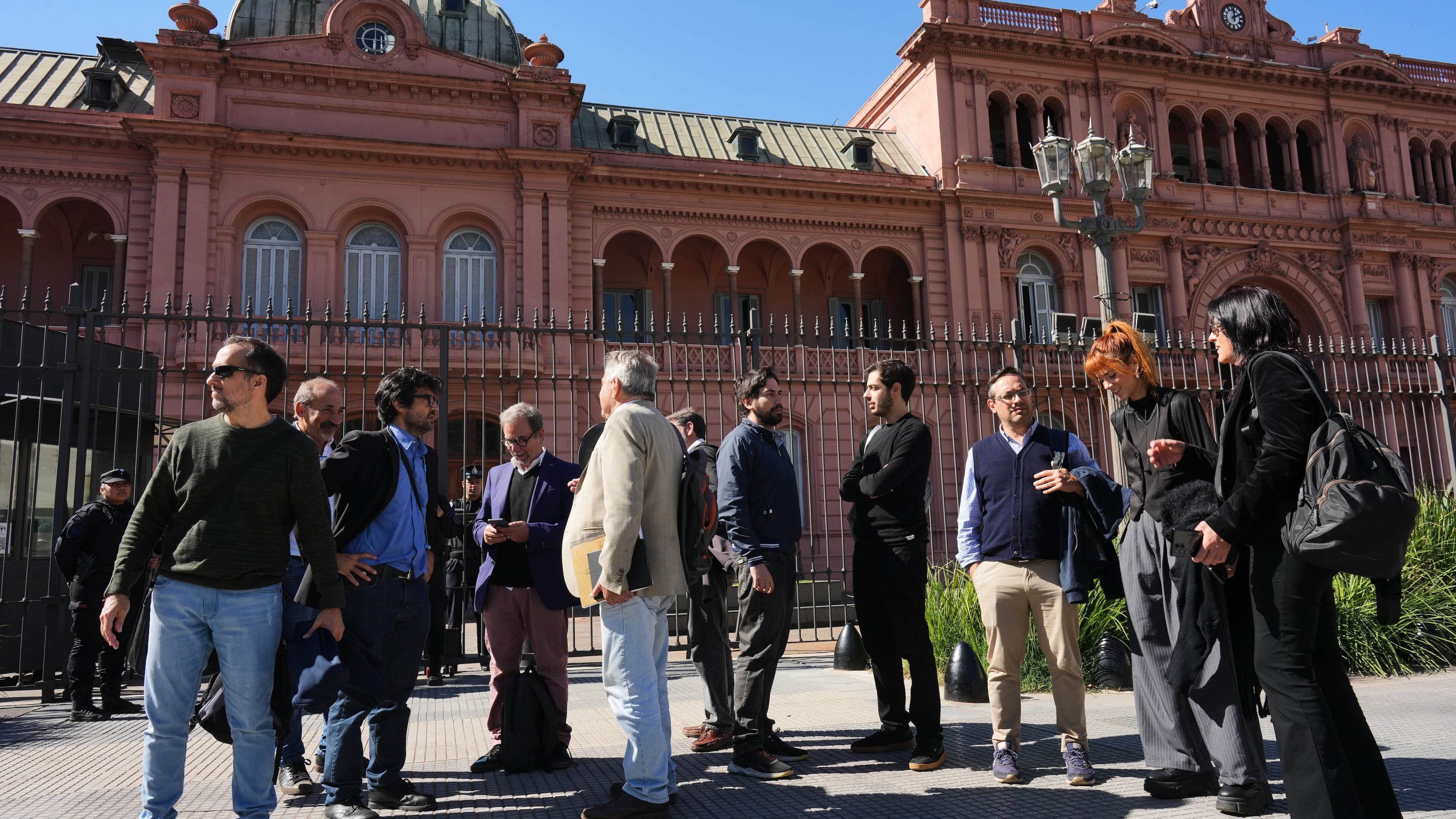 Journalists stand outside of the Casa Rosada government headquarters after President Javier Milei blocked their access, in Buenos Aires, Argentina, Thursday, April 23, 2026. (AP Photo/Rodrigo Abd)