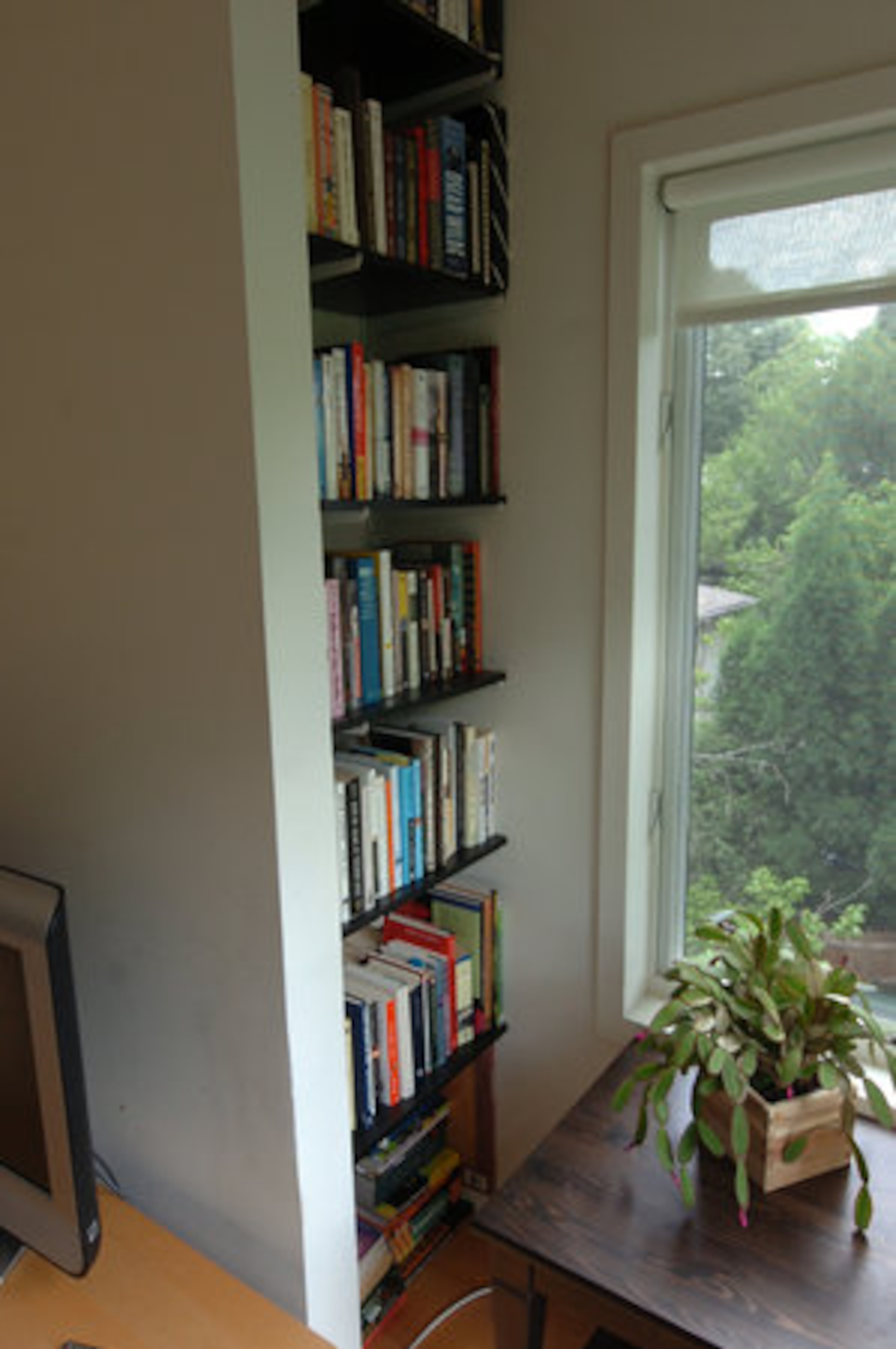 Above the bedrooms, a stairway leads to a loft area with more bookcases.