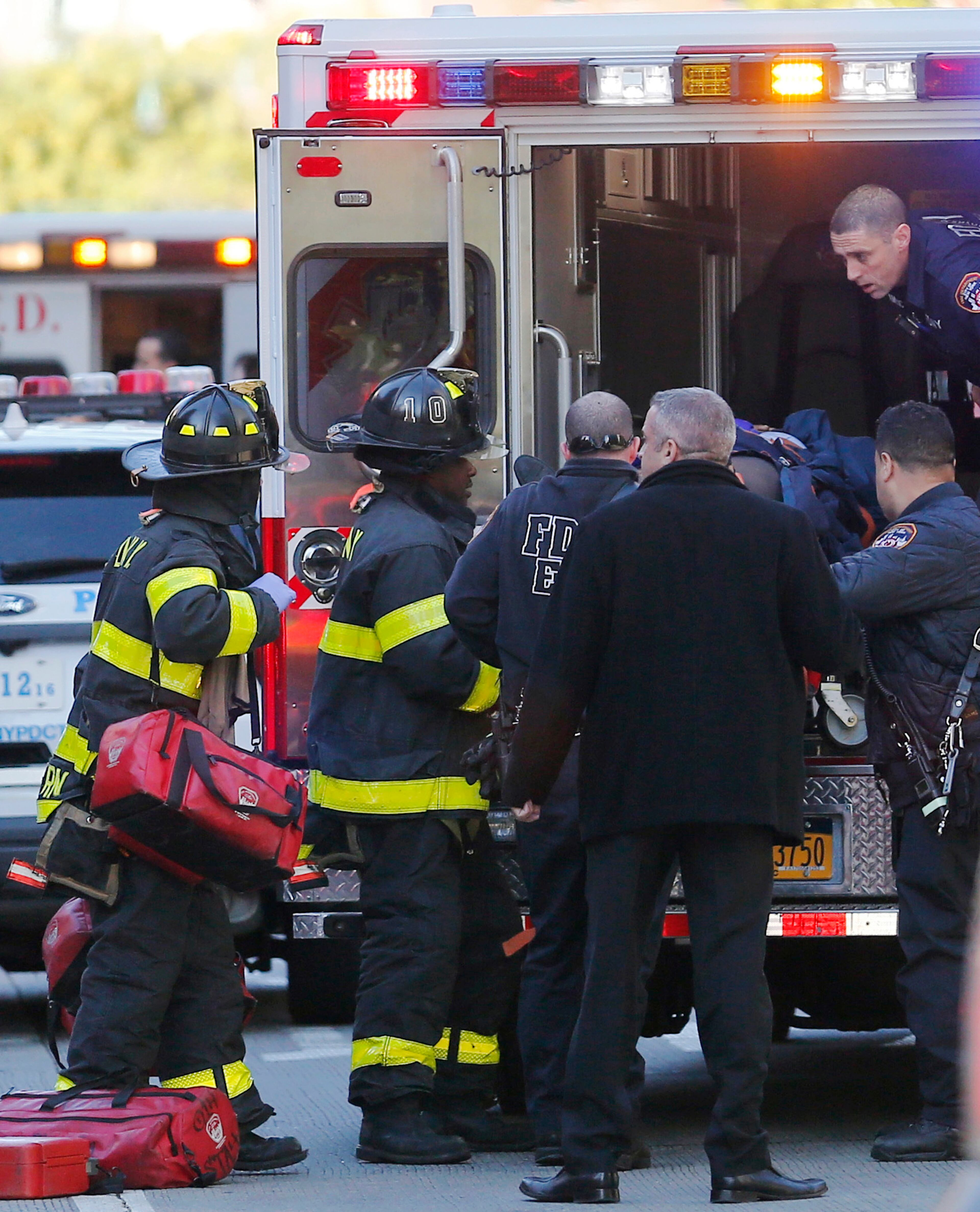 Paramedics lift an individual into an ambulance near the scene after reports of a deadly shooting Tuesday Oct. 31, 2017, in New York. A motorist drove onto a busy bicycle path near the World Trade Center memorial and struck several people Tuesday, police and witnesses said. (AP Photo/Bebeto Matthews)