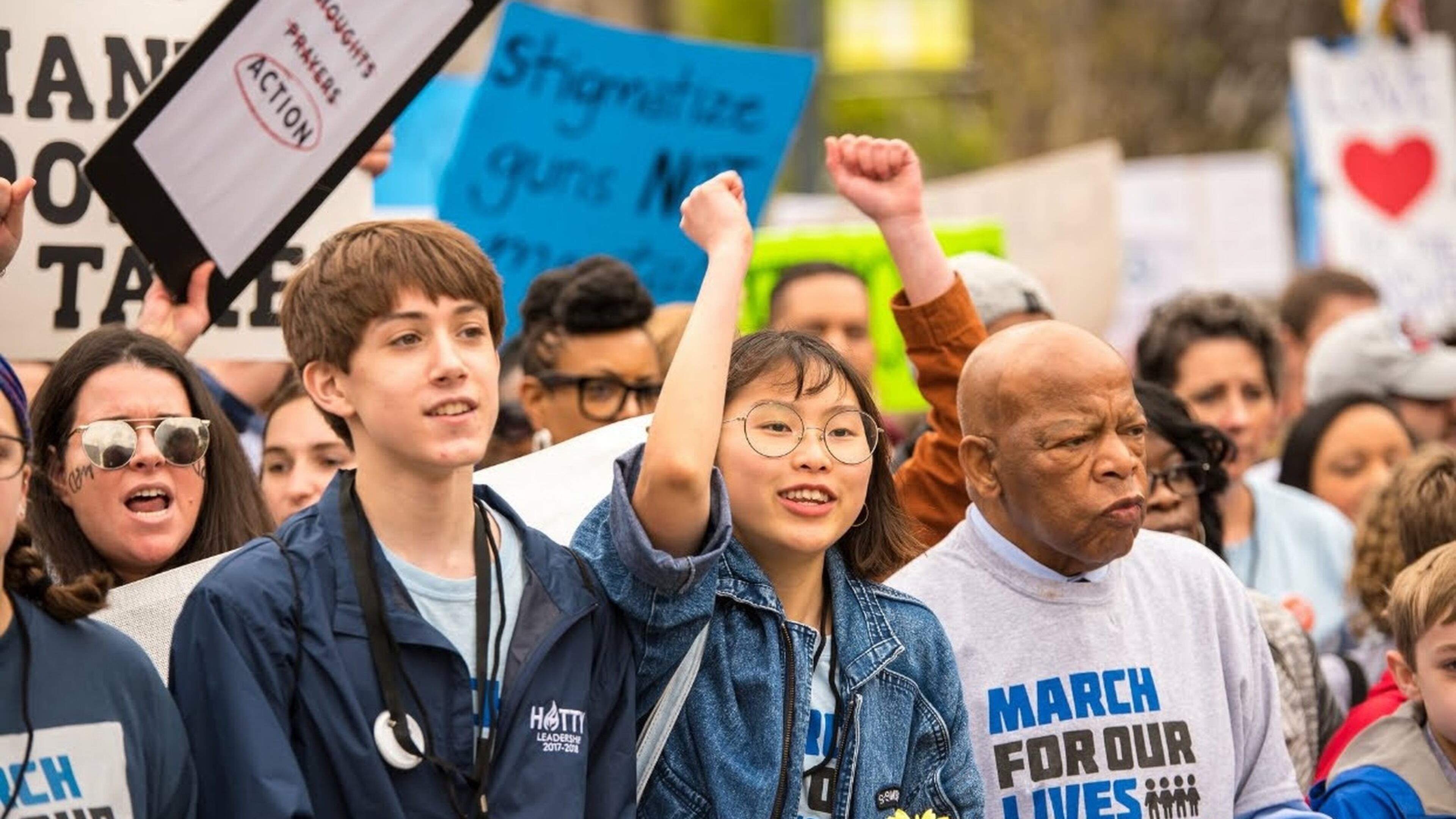 Ethan Asher, left, and Kailen Kim march with Congressman John Lewis at the March For Our Lives event in downtown Atlanta on March 24, 2018.