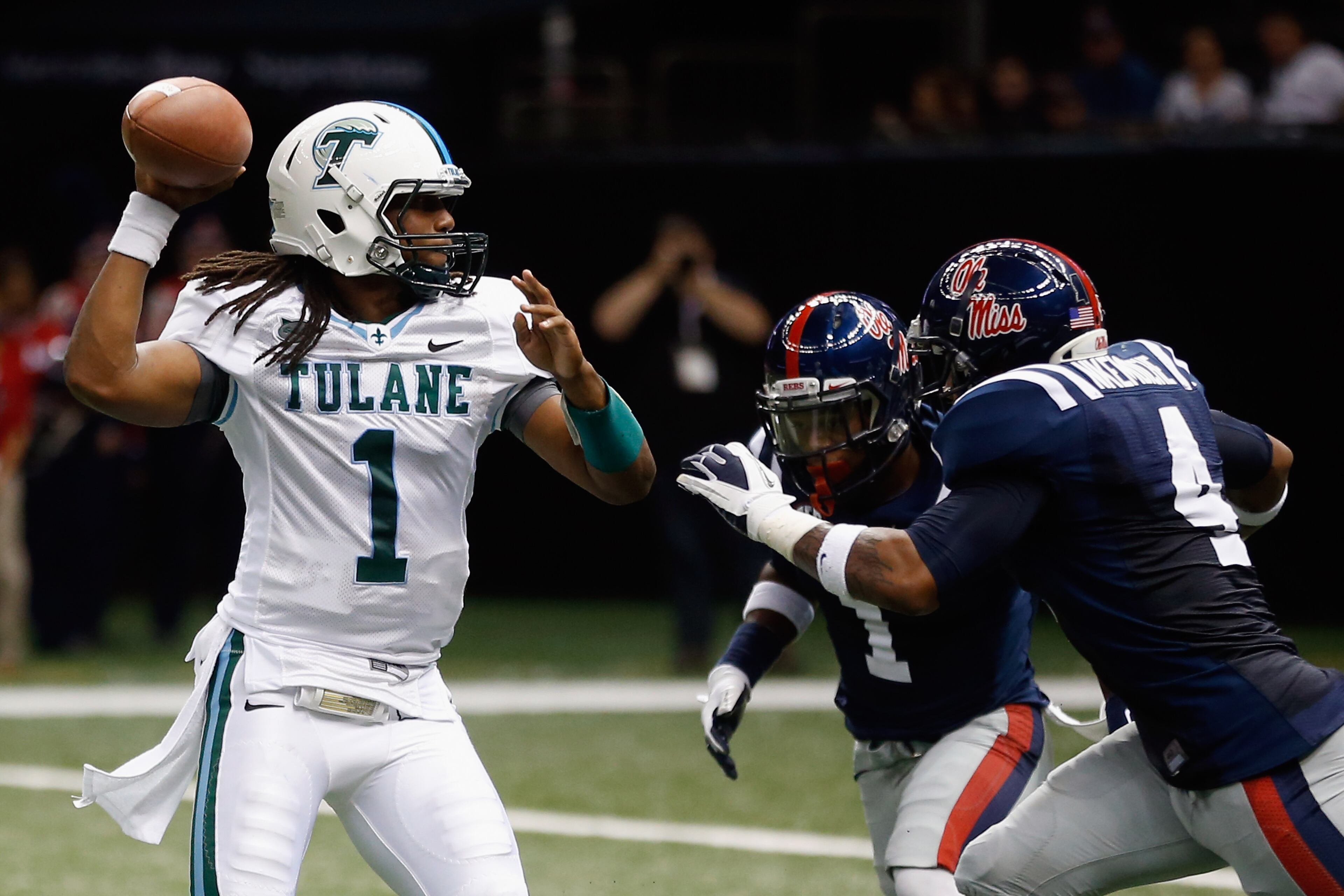 Devin Powell of the Tulane Green Wave throws under pressure by Denzel Nkemdiche (4) of the Mississippi Rebels