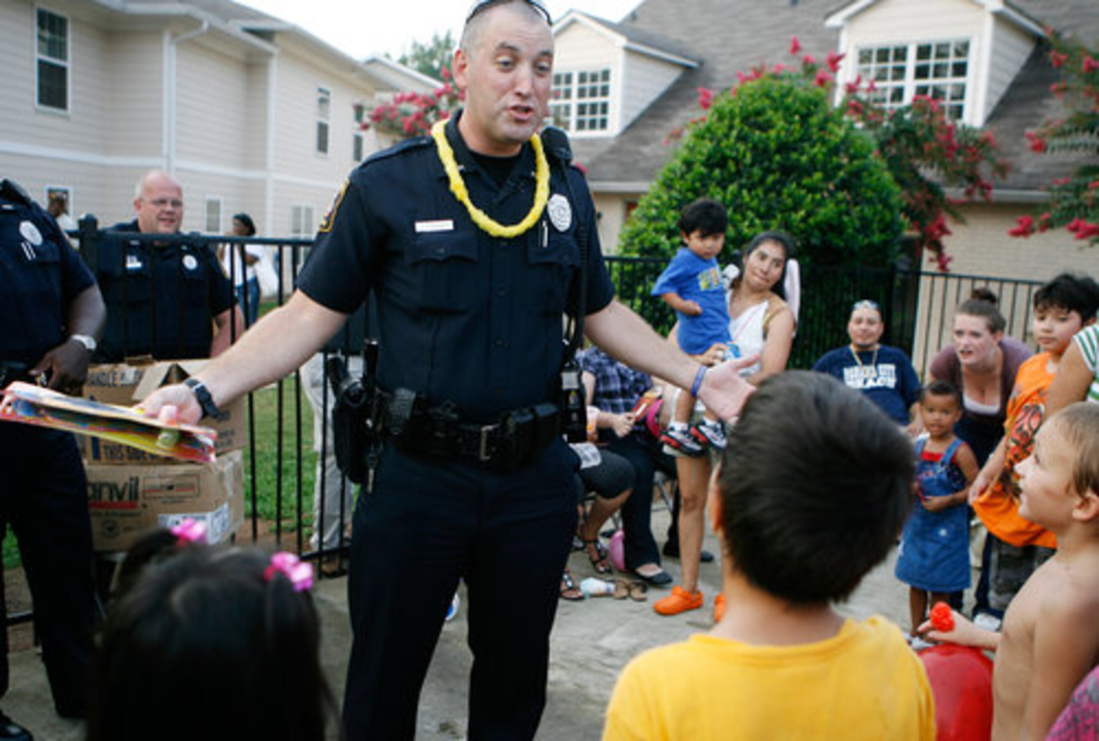 Marietta Police Officer Heath Henderson challenges two youngsters at Casa Mia Trace apartments to a game in order to win a prize. Violent crime in the area has declined 14 percent since 2006. Over the five-year program which ends in 2011, $824,000 will have been poured into the community to pay for extra policing and community service.