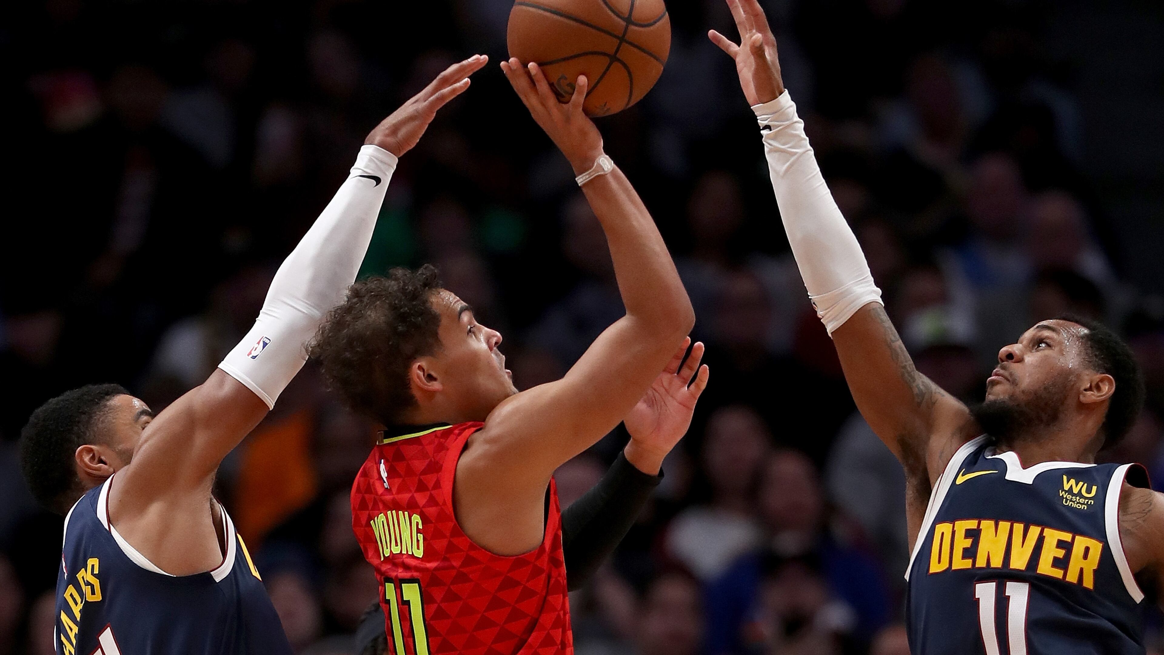 Trae Young of the Hawks puts up a shot against the Nuggets. (Photo by Matthew Stockman/Getty Images)