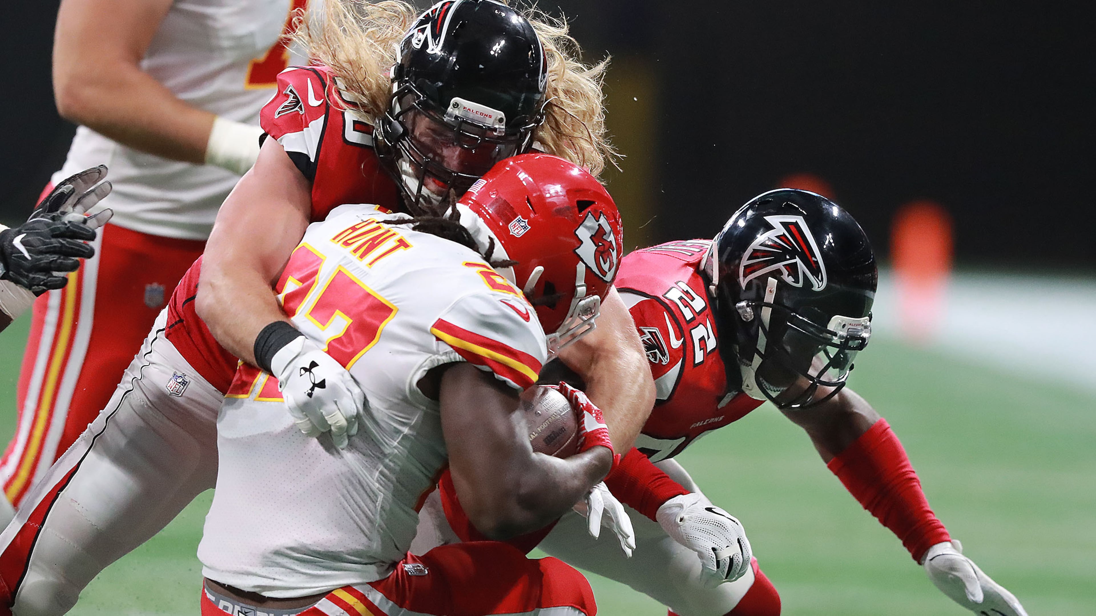 Falcons safety Keanu Neal (right) is called for a helmet penalty of 15 yards for hitting Chiefs running back Kareem Hunt (with help from defensive end Brooks Reed) during the first quarter Friday, Aug. 17, 2018, at Mercedes-Benz Stadium in Atlanta.