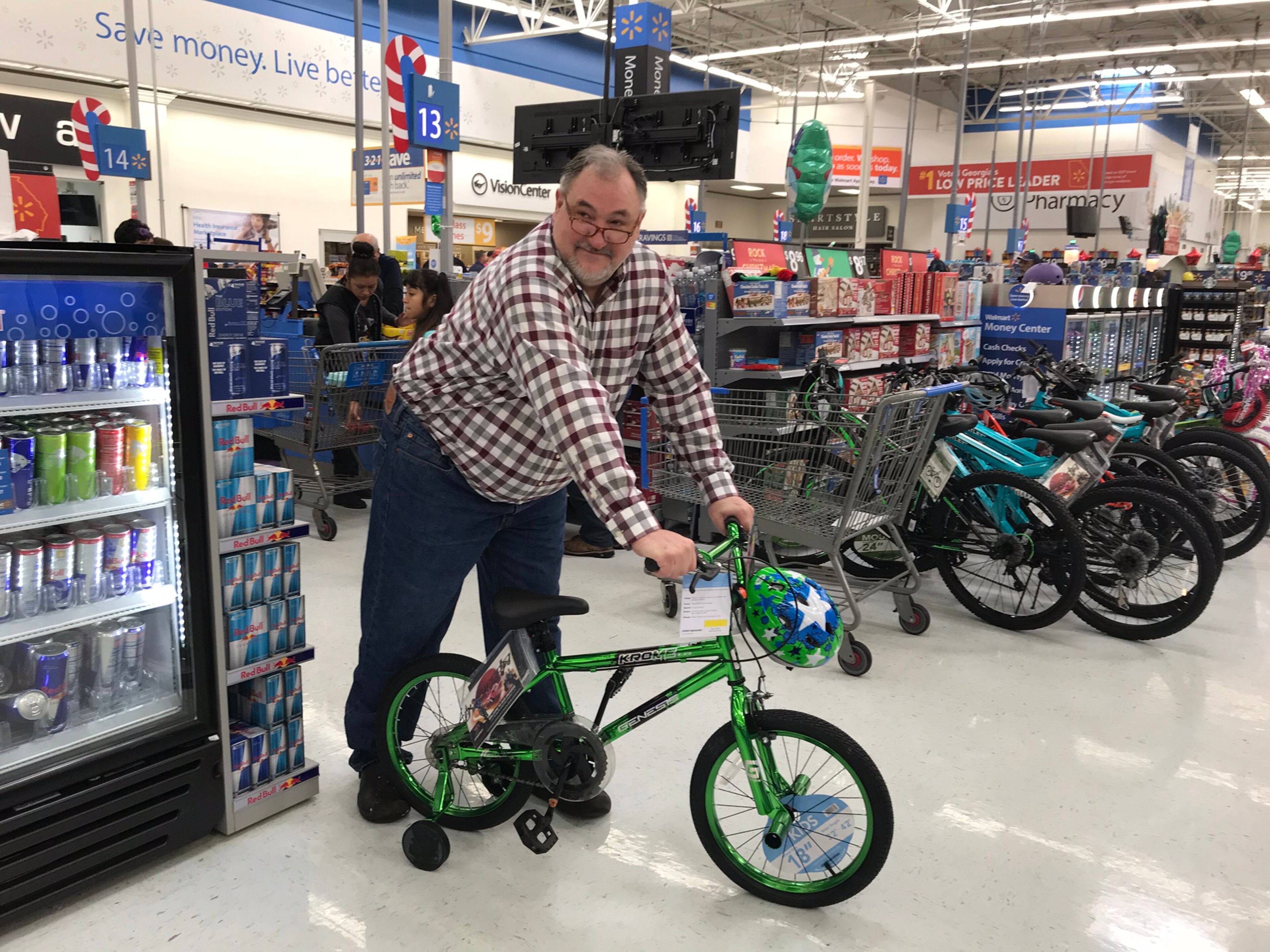 Tony Nix of Duluth awaits his partner, who is finishing shopping for an eight-year-old in Catoosa County. This is at least his fifth year doing this. CREDIT: Rodney Ho/rho@ajc.com