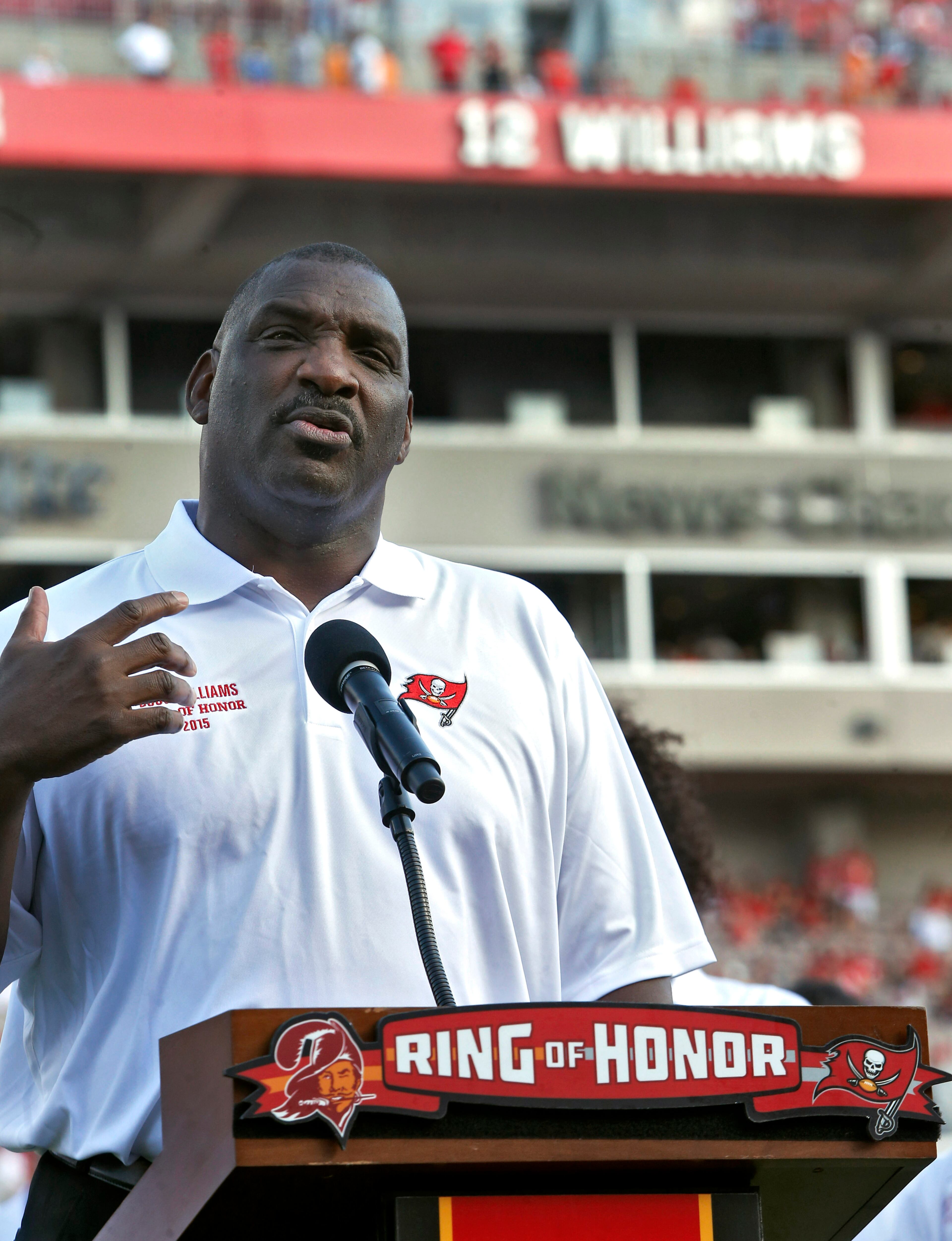 Former Tampa Bay Buccaneers quarterback Doug Williams gestures as he is inducted in the team's ring of Honor during halftime in an NFL football game against the Atlanta Falcons Sunday, Dec. 6, 2015, in Tampa, Fla. (AP Photo/Brian Blanco)