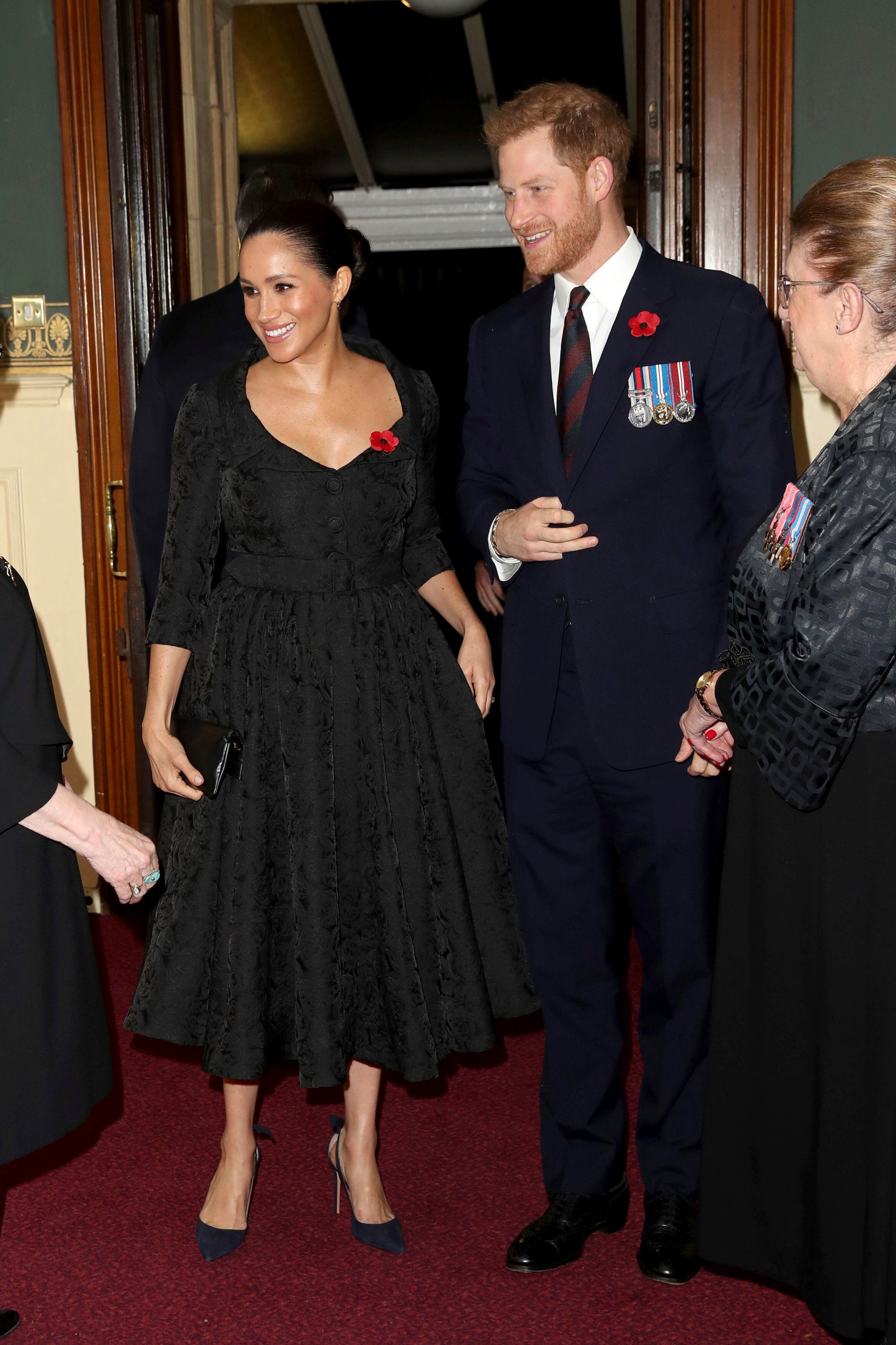 Britain's Prince Harry, right and his wife, Meghan, the Duchess of Sussex, arrive for the annual Royal British Legion Festival of Remembrance, at the Royal Albert Hall in Kensington, London, Saturday, Nov. 9, 2019. (Chris Jackson/Pool Photo via AP)