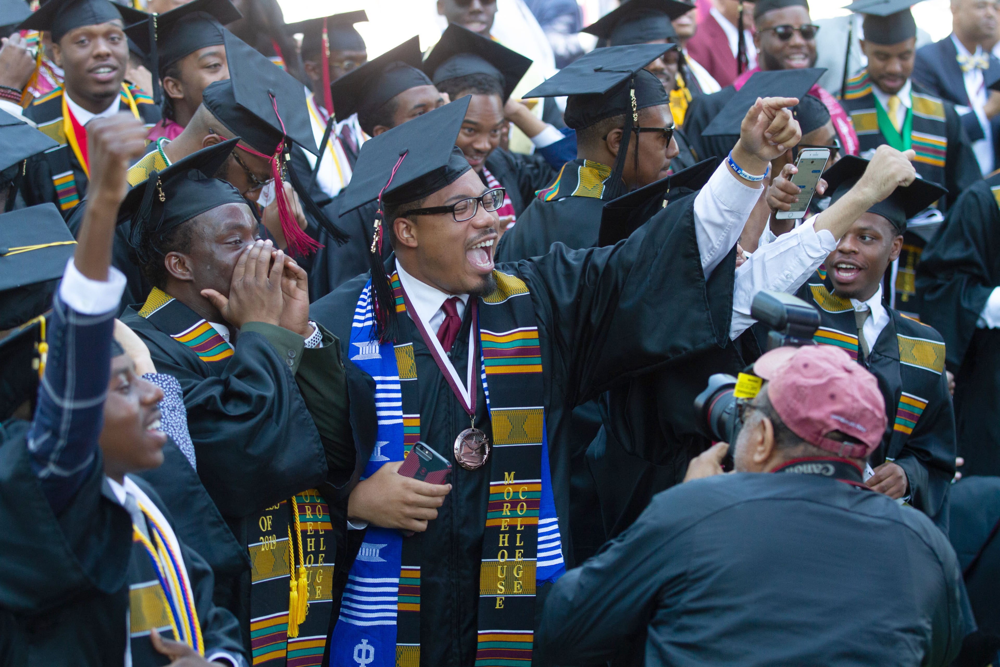 Graduates react after hearing billionaire, Robert F. Smith is paying all student debt for the class of 2019 during the Morehouse College graduation ceremony in Atlanta on Sunday, May 19, 2019. STEVE SCHAEFER / SPECIAL TO THE AJC