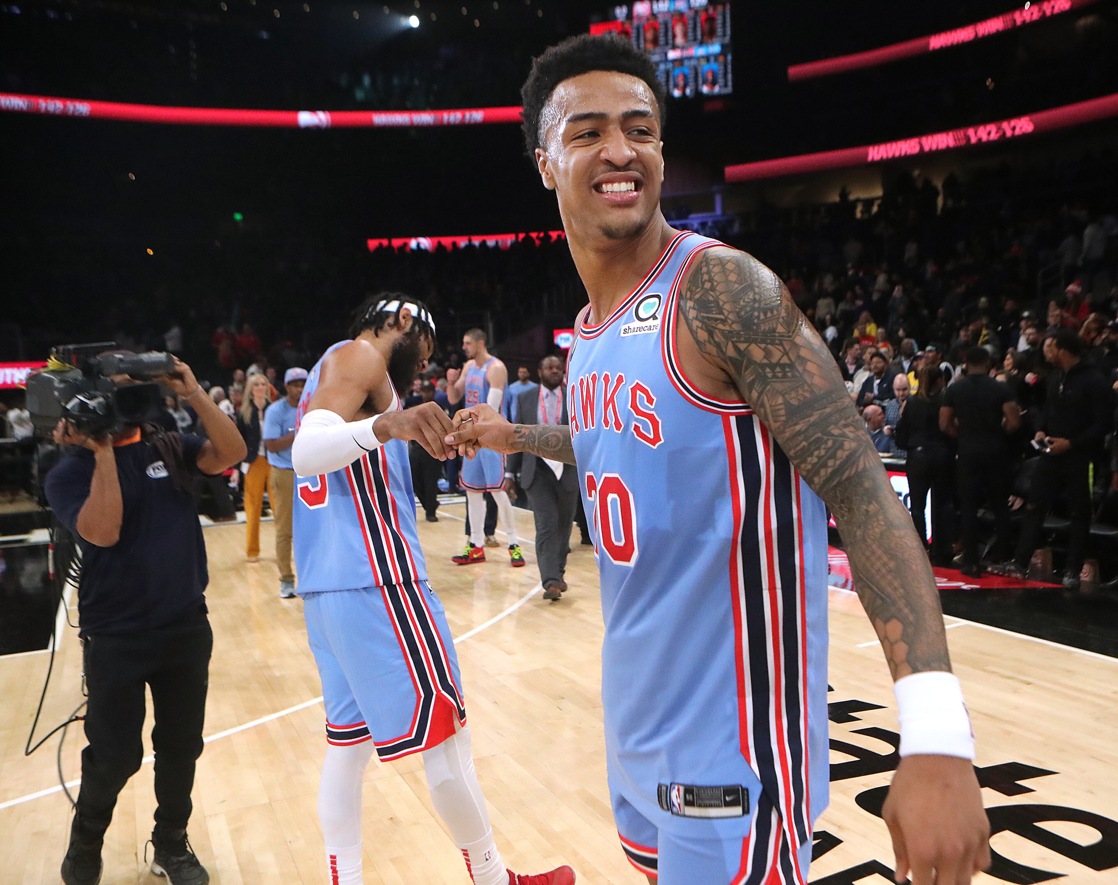 Atlanta Hawks forwards John Collins (right) and DeAndre Bembry celebrate a 142-126 victory over the Oklahoma City Thunder in a NBA basketball game on Tuesday, Jan. 15, 2019, at State Farm Arena in Atlanta. Curtis Compton/ccompton@ajc.com