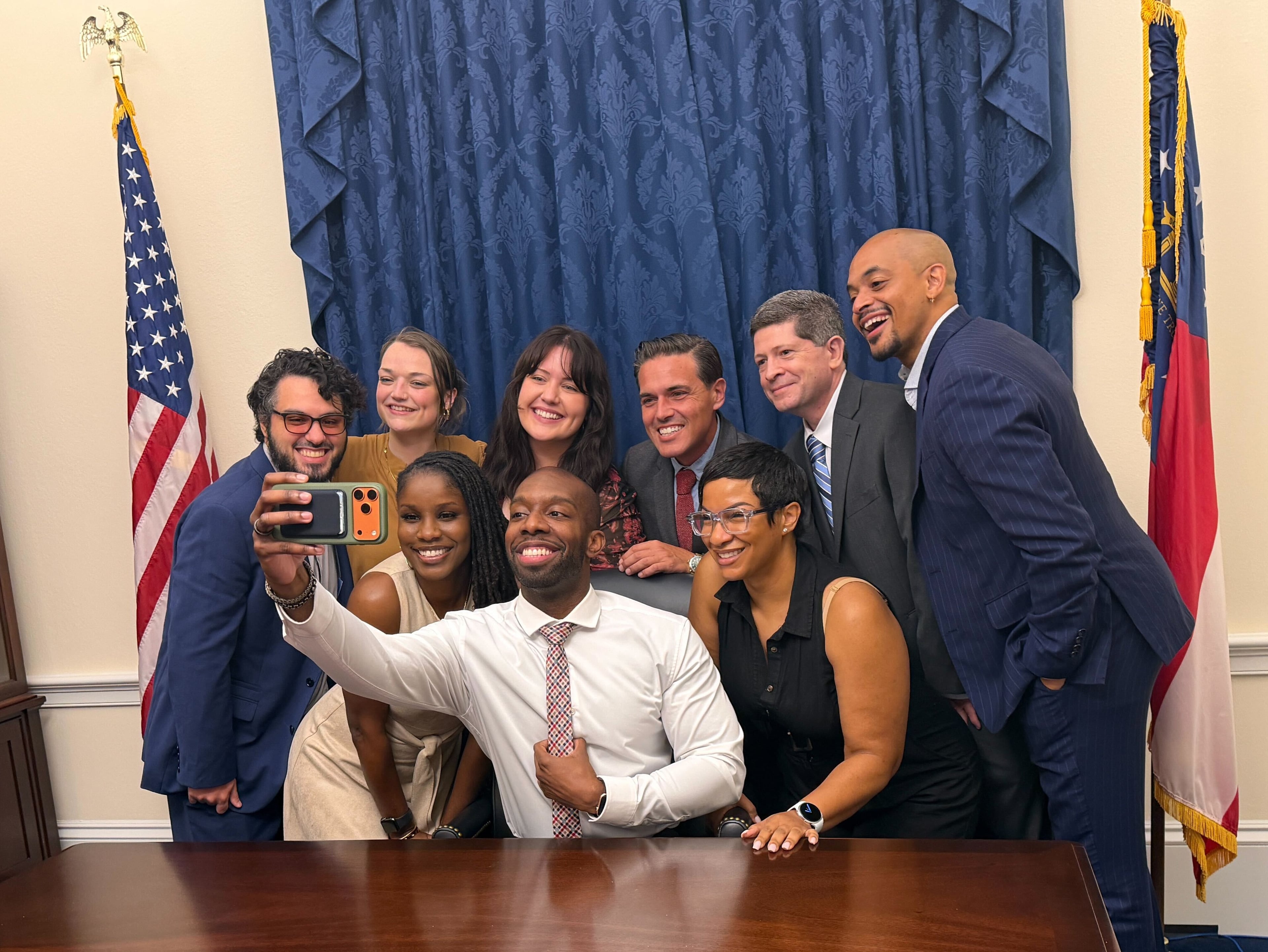 U.S. Rep. Everton Blair takes a selfie with members of his campaign team on the date of his swearing in, Sept. 1, 2026.
