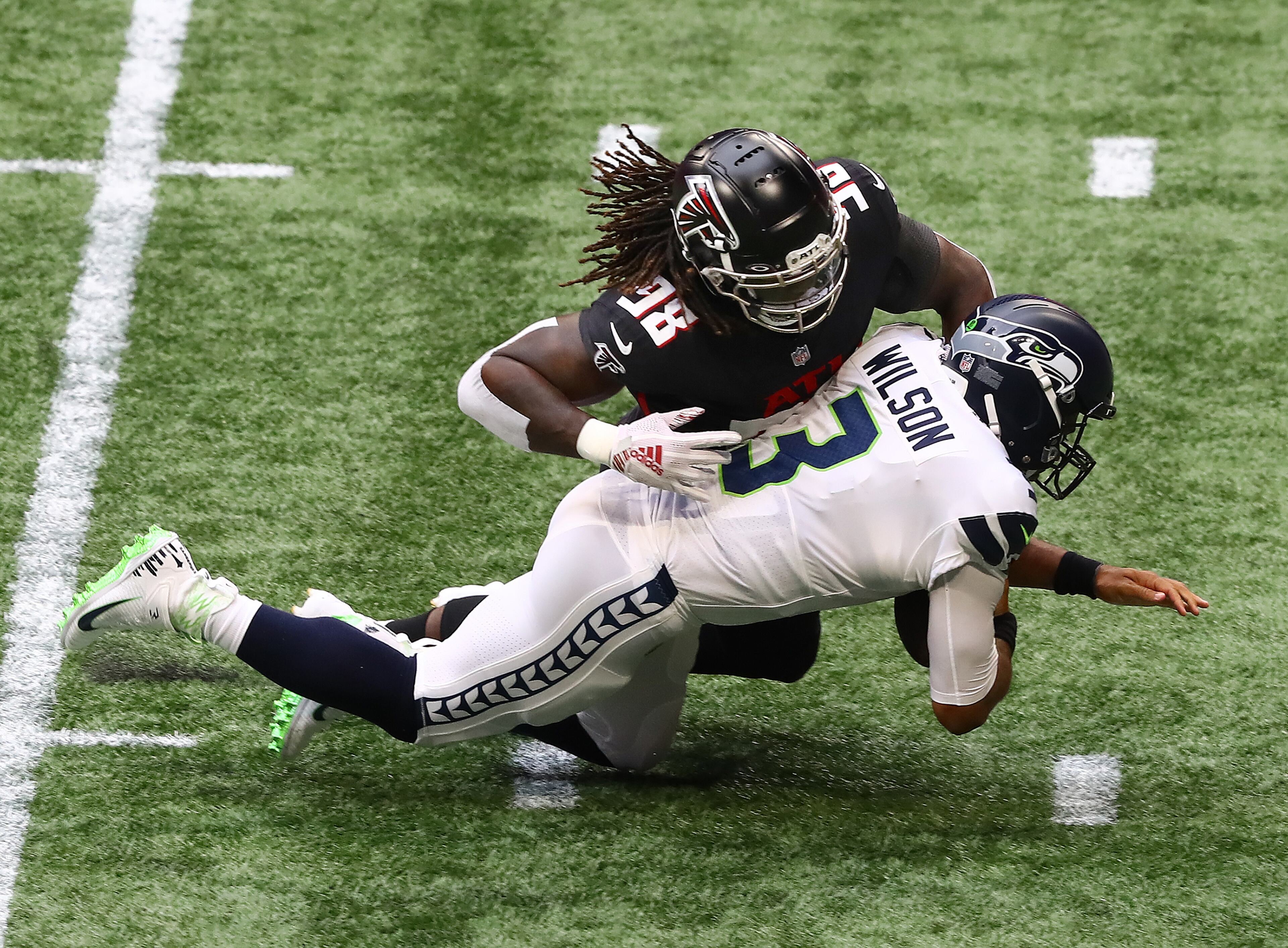 Falcons defensive end Takk McKinley sacks Seattle Seahawks quarterback Russell Wilson on his first offensive play during the first quarter Sunday, Sept. 13, 2020 in Atlanta. (Curtis Compton / Curtis.Compton@ajc.com)