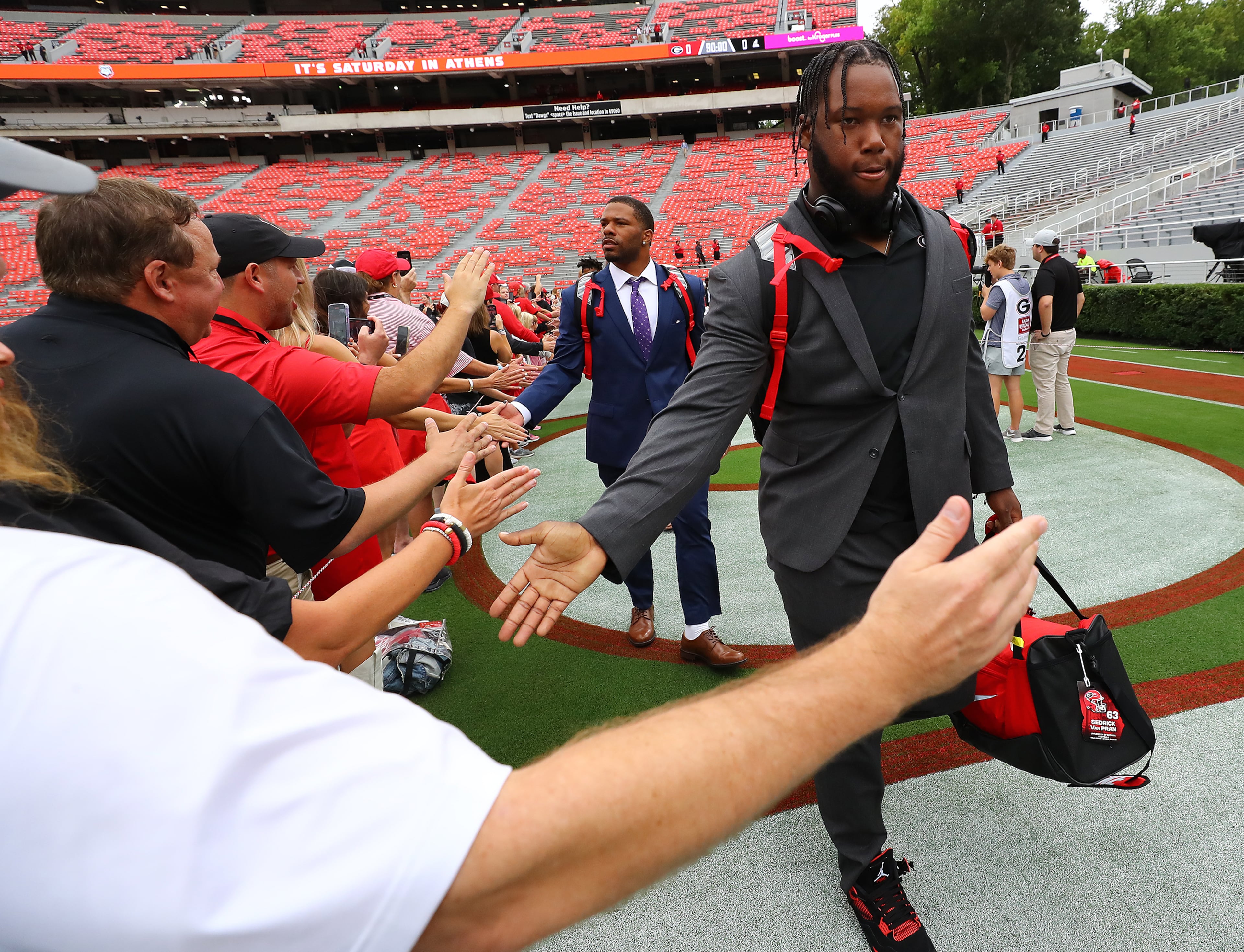 Georgia offensive lineman Sedrick Van Pran and teammates give fans five during the Dawg Walk before playing Samford in a NCAA college football game on Saturday, Sept. 10, 2022, in Athens. “Curtis Compton / Curtis Compton@ajc.com