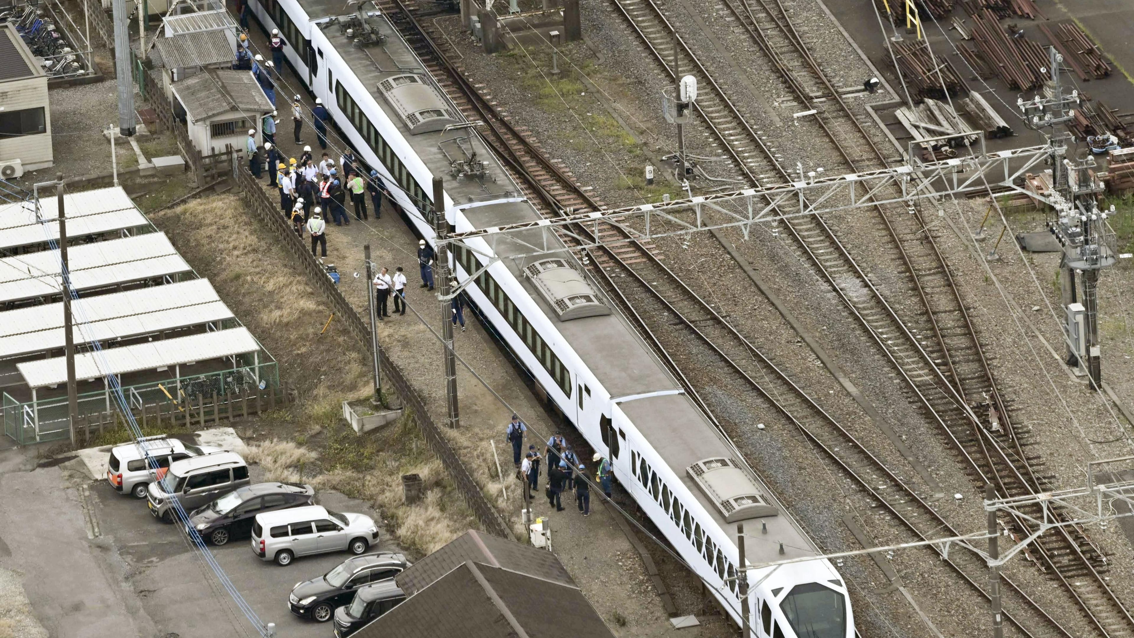 This aerial photo shows, the Spacia X express train stopped after coming into contact with four workers at Shin-Kanuma Station on the Tobu Nikko Line in Kanuma, north of Tokyo, Thursday, Aug. 20, 2026. (Kyodo News via AP)