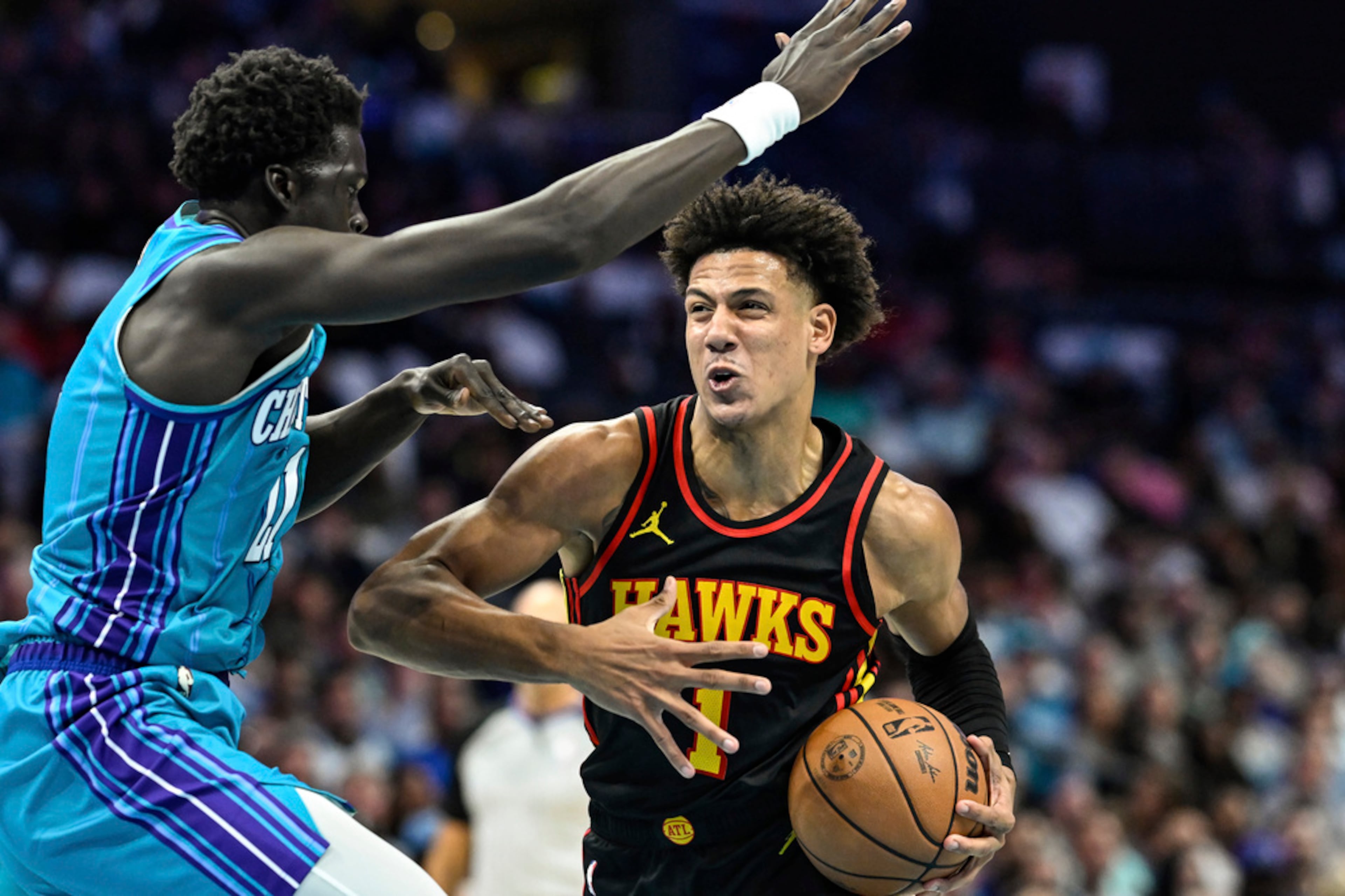 Atlanta Hawks forward Jalen Johnson (1) attempts to drive past Charlotte Hornets forward JT Thor during the second half of an NBA basketball game Wednesday, Oct. 25, 2023, in Charlotte, N.C. (AP Photo/Matt Kelley)