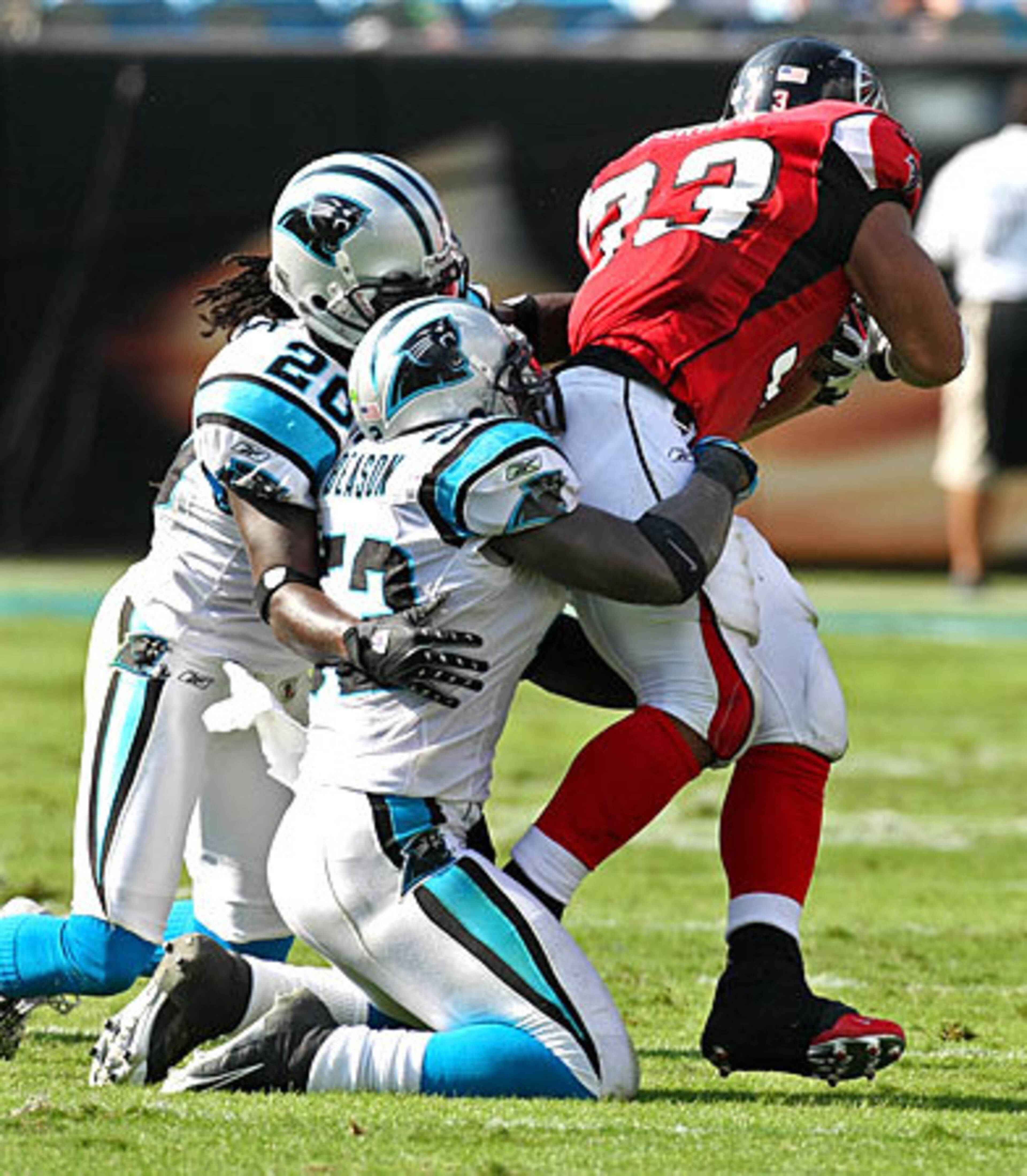 Panthers defenders cornerback #20 Chris Gamble and linebacker #52 Jon Beason grabbed a hold of Turner.