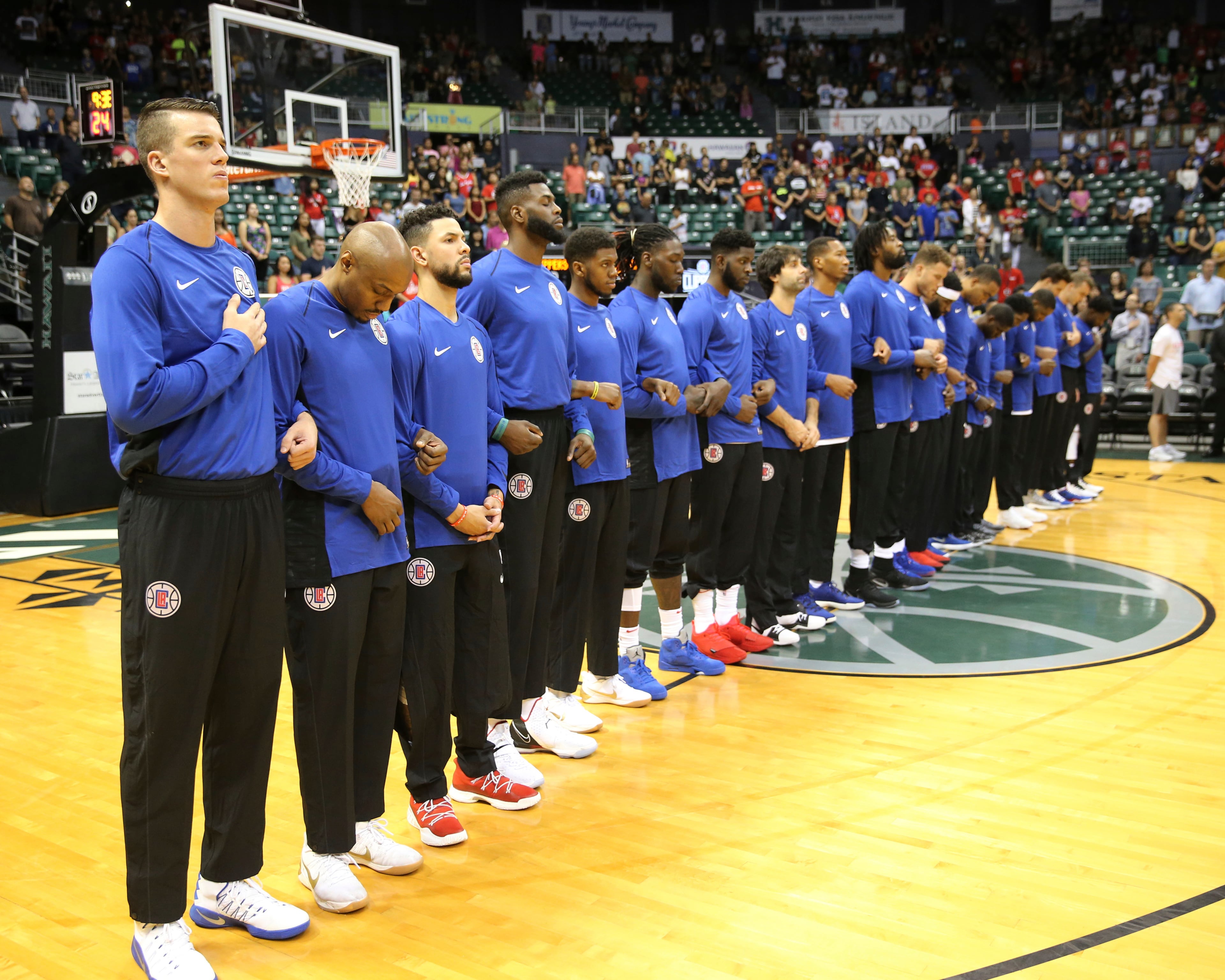 The Los Angeles Clippers stand during the national anthem on Sunday, Oct. 1.