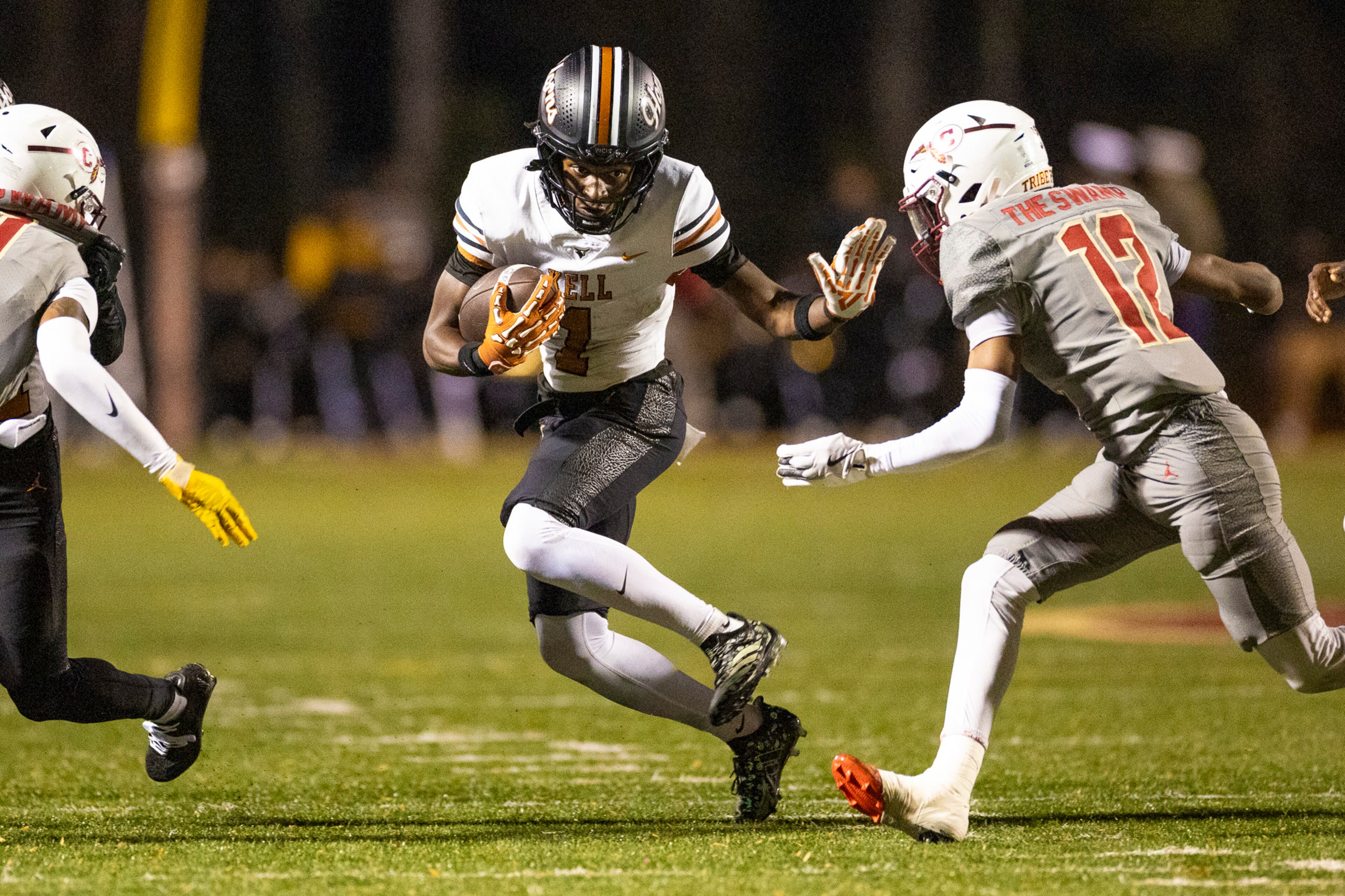 Kell linebacker Michael Domanik (center) blocks Creekside cornerback Tyree Colzie during the first half of their Class 4A semifinal game on Friday, Dec. 5, 2025, at Creekside High School in Fairburn. (Oscar Guevara Saenz for the AJC)