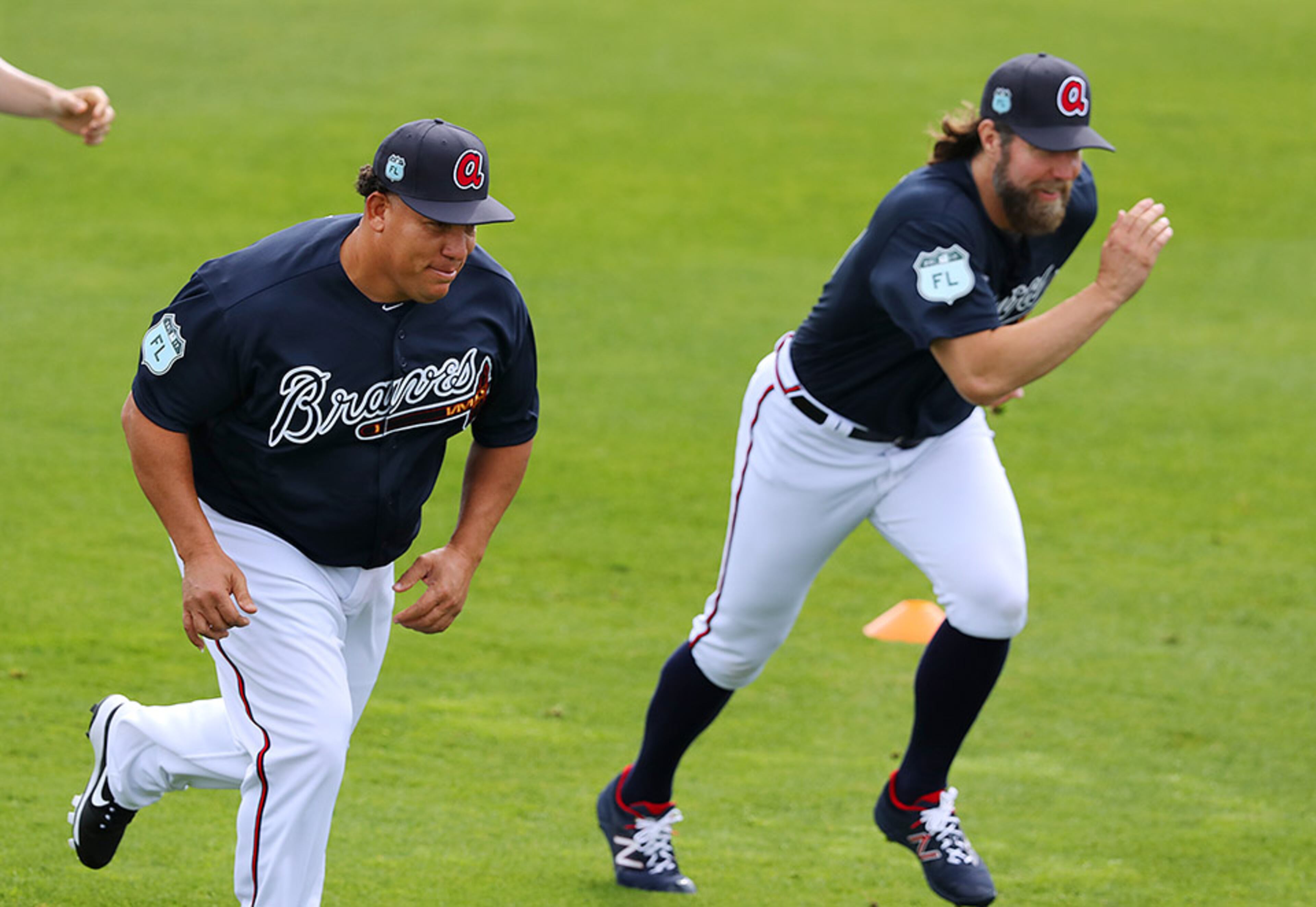 New Braves pitchers Bartolo Colon (left) and R.A. Dickey race each other during sprints Wednesday Feb. 15, 2017, at Champion Stadium at the ESPN Wide World of Sports in Lake Buena Vista. Braves pitchers and catcher worked out for the first time during spring training Wednesday.