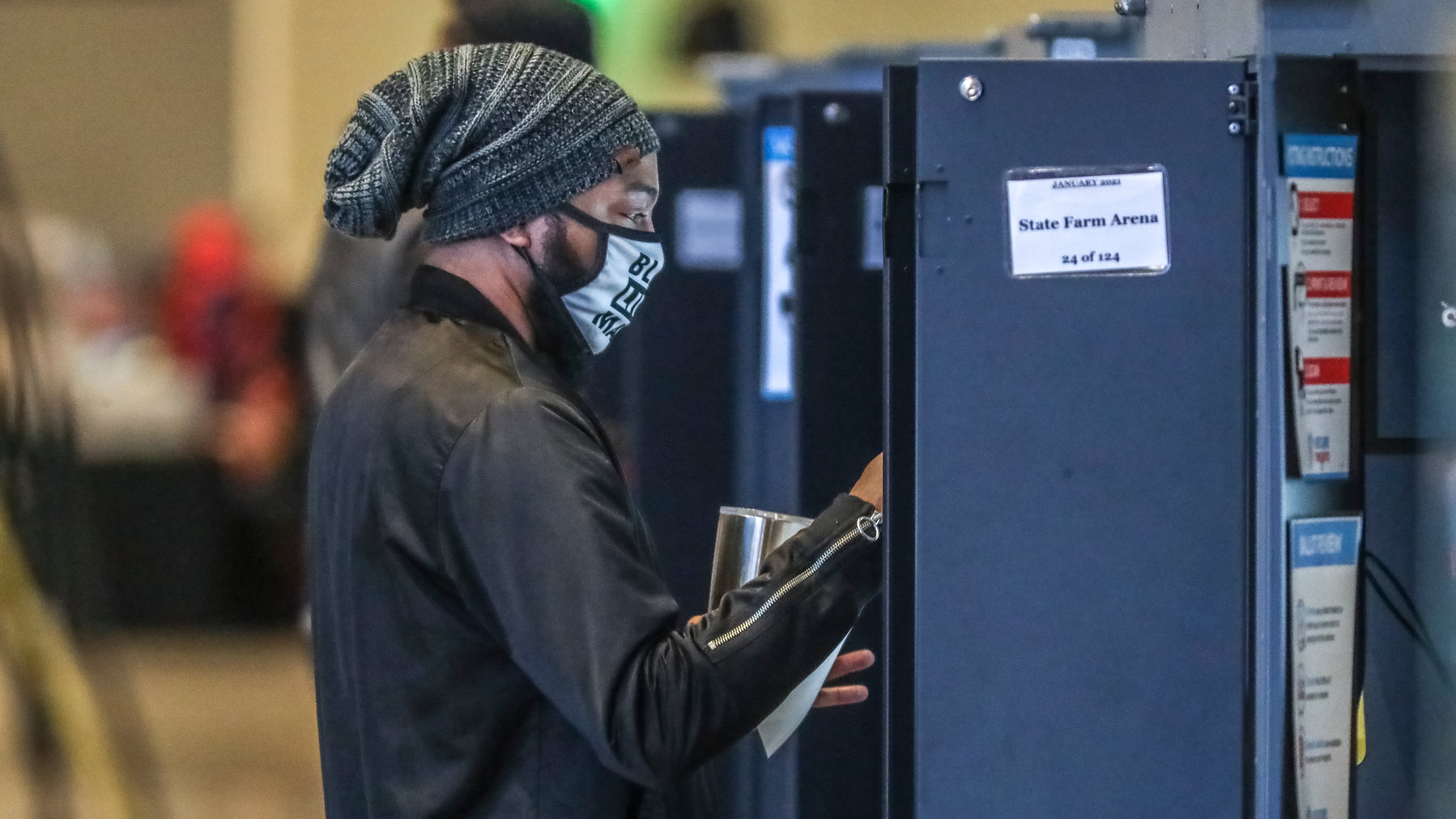 December 14, 2020 Atlanta: Voters came to State Farm Arena on Monday, Dec. 14, 2020 to cast their votes to determine which political party controls the U.S. Senate on the first day of early voting. Both of Georgia’s Senate seats are up for grabs as Republican incumbent Sens. David Perdue and Kelly Loeffler try to hold of Democratic challengers Jon Ossoff and Raphael Warnock. Democrats would need to win both seats to flip control of the Senate. Early voting started at 8:30 a.m. in Fulton County. Thirty-two voting locations are open and listed on the Fulton County website. Early voting locations were also open elsewhere in the state, including in Cobb, DeKalb and Gwinnett counties. Early voters may cast their ballot at any location in their county. In Fulton County, weekday voting hours are 8:30 a.m.-6 p.m. through Dec. 23. Hours are extended to 7 a.m.-7 p.m. from Dec. 28-30. On Saturdays, Dec. 19 and Dec. 26, voting will be held 8:30 a.m.-6 p.m. On Sundays, Dec. 20 and Dec. 27, voting locations are open noon-6 p.m. Voting locations include State Farm Arena from Dec. 14-19; and Mercedes-Benz Stadium from Dec. 22-Dec. 30. Wait time estimates at polling locations will available on the Fulton County website and the Fulton Votes mobile app, an official said. Polls will be closed Dec. 24-25 and Dec. 31-Jan. 1 in observance of the Christmas and New Year’s holidays. Election Day is Tuesday, Jan. 5. (John Spink / John.Spink@ajc.com)