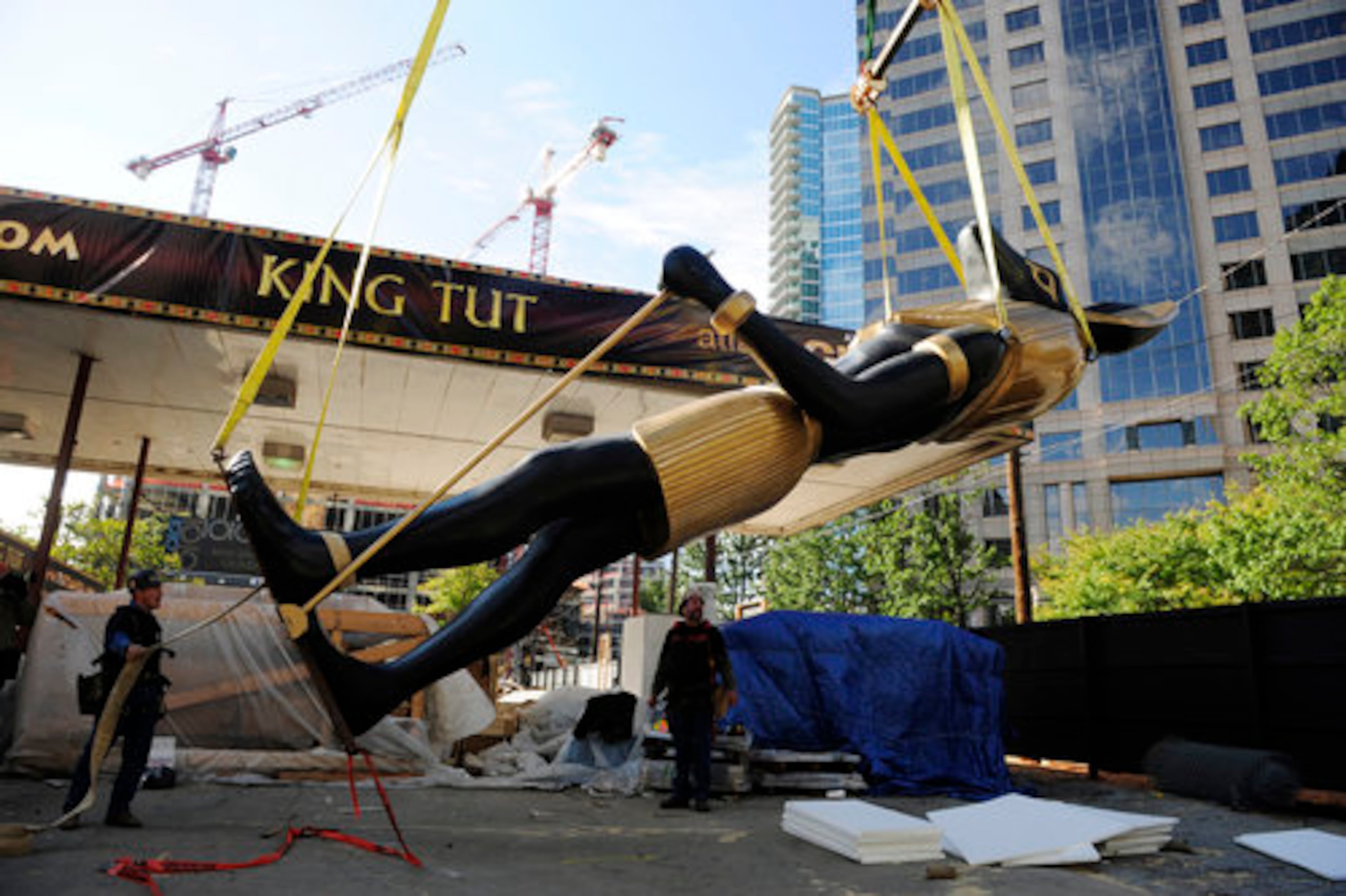 Wallace (left) and rigger Roger Fain guide the five ton, 25-foot tall statue, which is being installed for the U.S. premiere of "Tutankhamun: The Golden King and the Great Pharoahs."