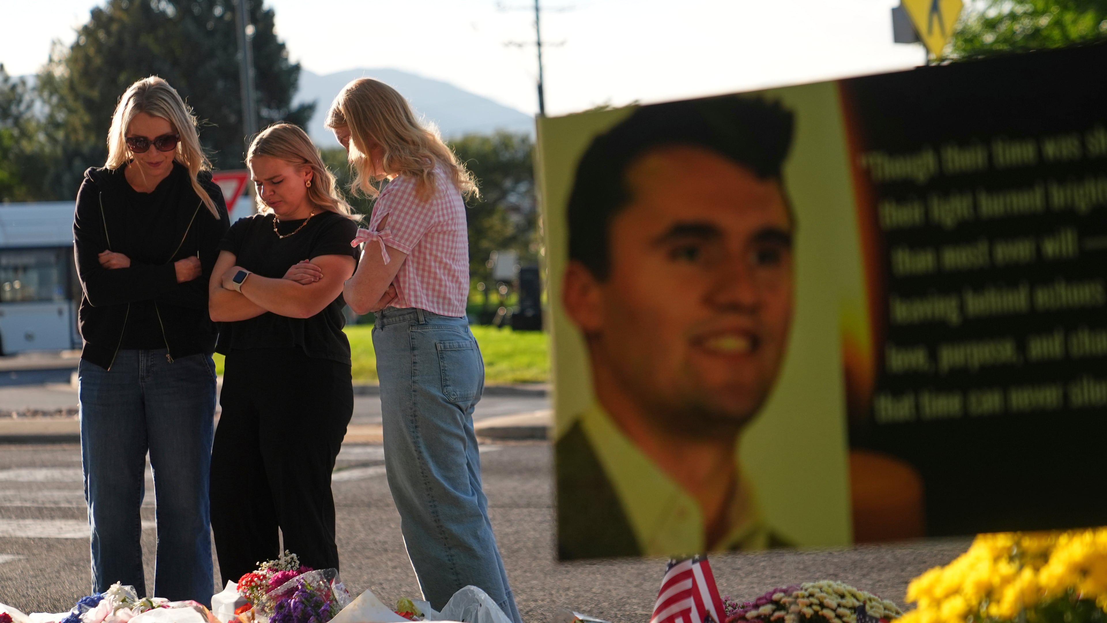 FILE - Women pray at a memorial outside Utah Valley University after Turning Point USA CEO and co-founder Charlie Kirk was shot and killed, Sept. 13, 2025, in Orem, Utah. (AP Photo/Lindsey Wasson, File)