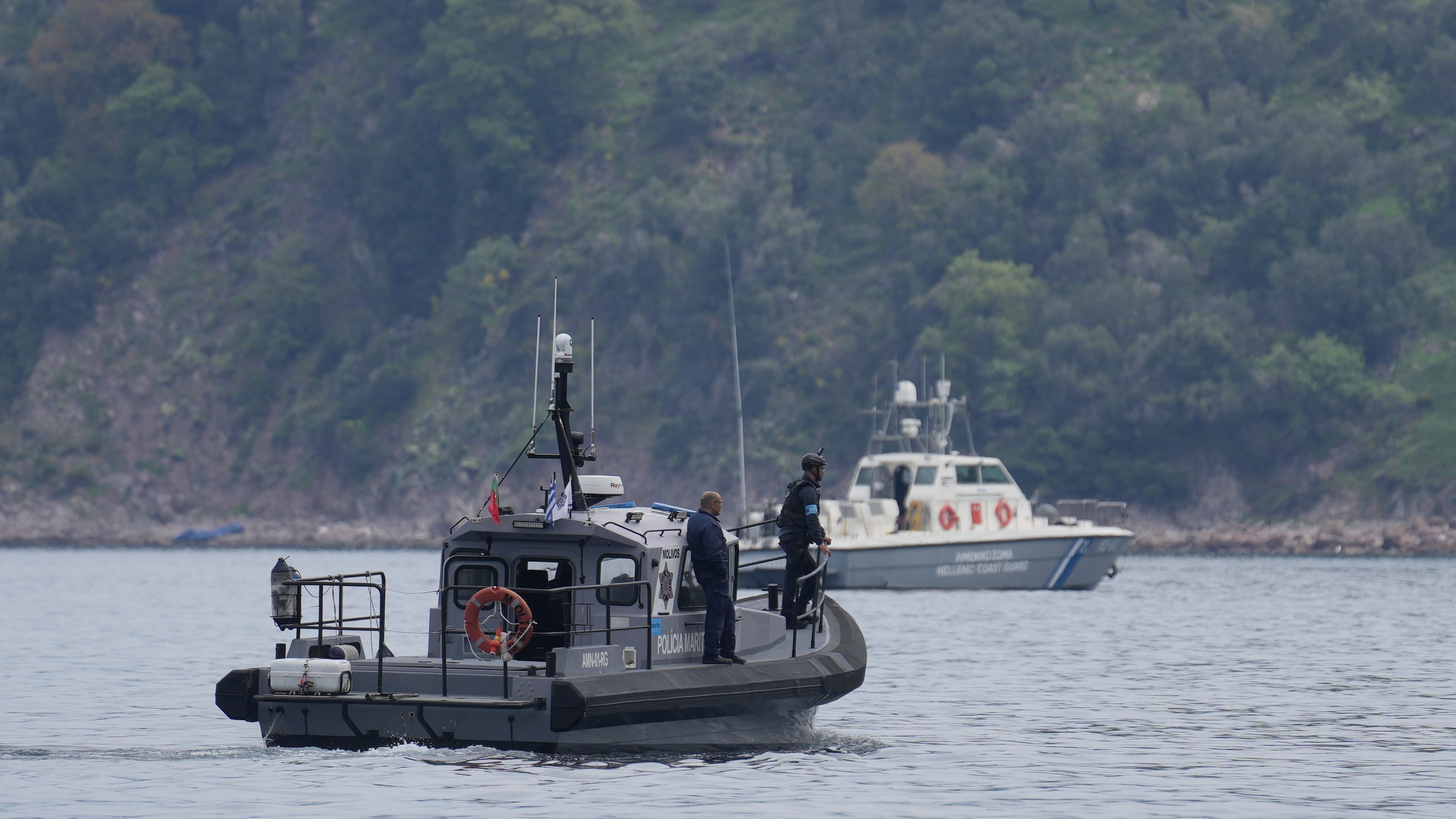 FILE - Frontex, foreground, and Greek coast guard vessels take part in a search and rescue operation, after the capsizing of a boat carrying migrants, off the coast on the northeastern Aegean Sea island of Lesbos, Greece, on April 3, 2025. (AP Photo/Panagiotis Balaskas, File)