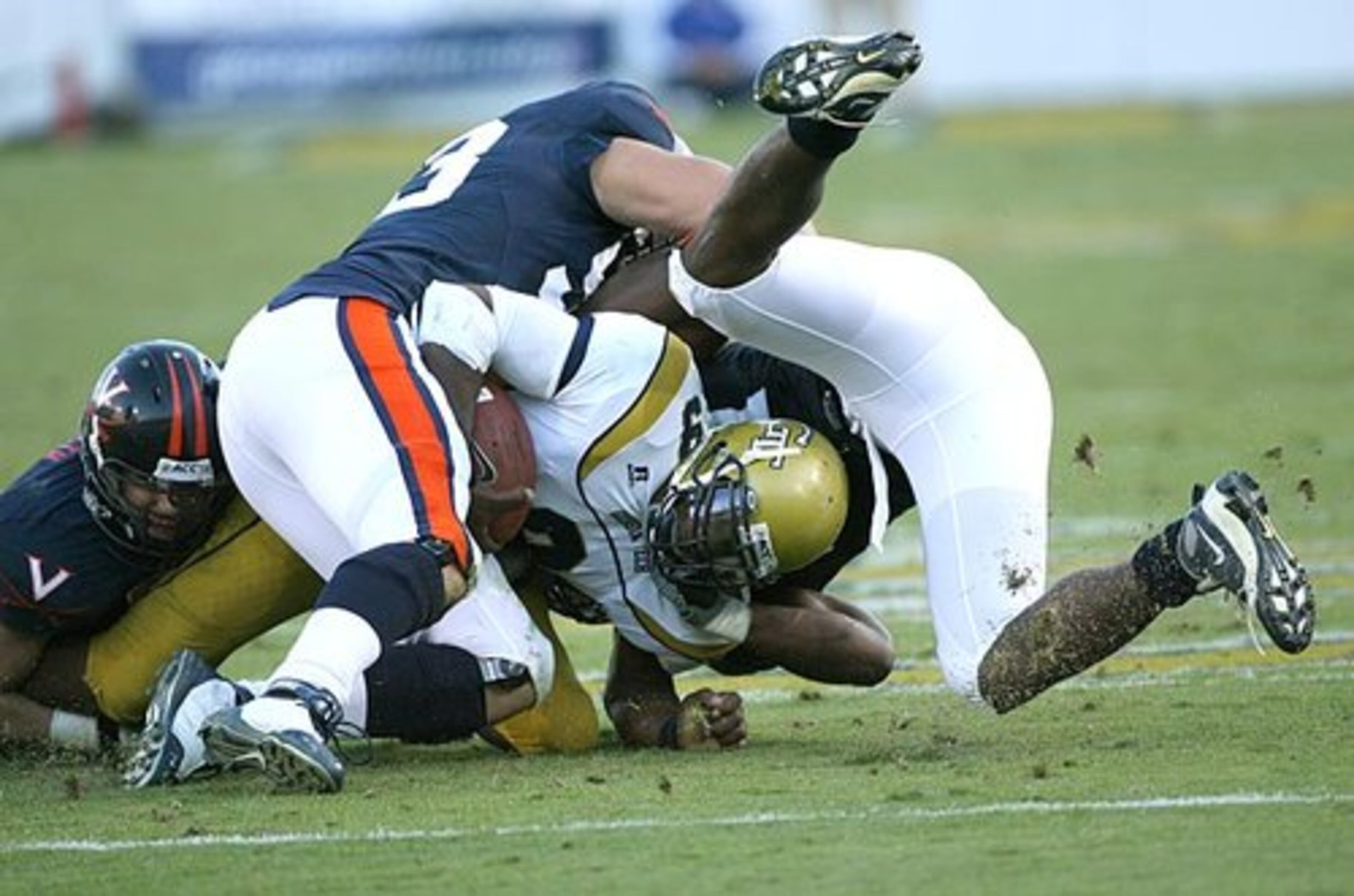 Georgia Tech's Josh Nesbitt is tackled by a gang of Virginia defenders during Tech's last drive in the fourth quarter.
