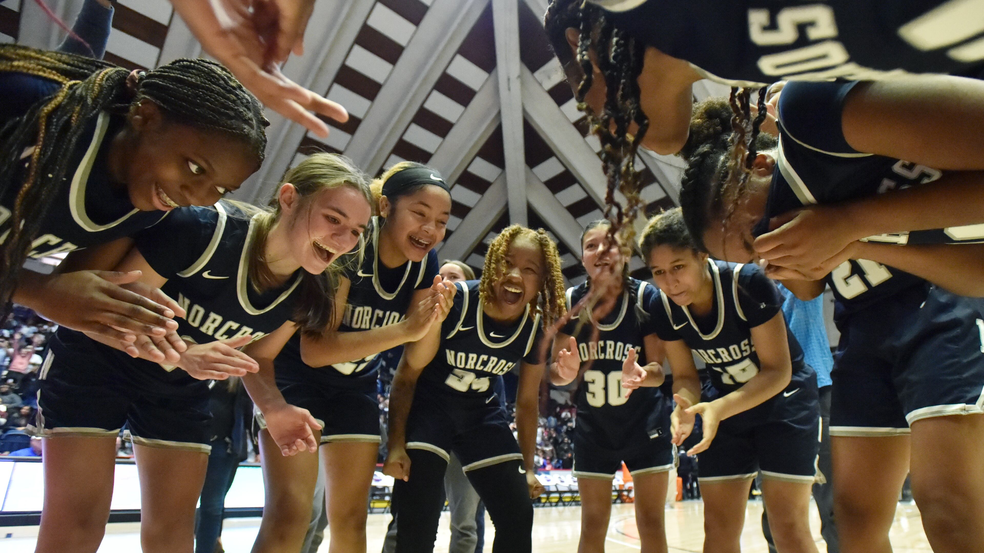 March 12, 2022 Macon - Norcross players celebrate their victory over Harrison during the 2022 GHSA State Basketball Class AAAAAAA Girls Championship game at the Macon Centreplex in Macon on Saturday, March 12, 2022. Norcross won 41-37 over Harrison. (Hyosub Shin / Hyosub.Shin@ajc.com)