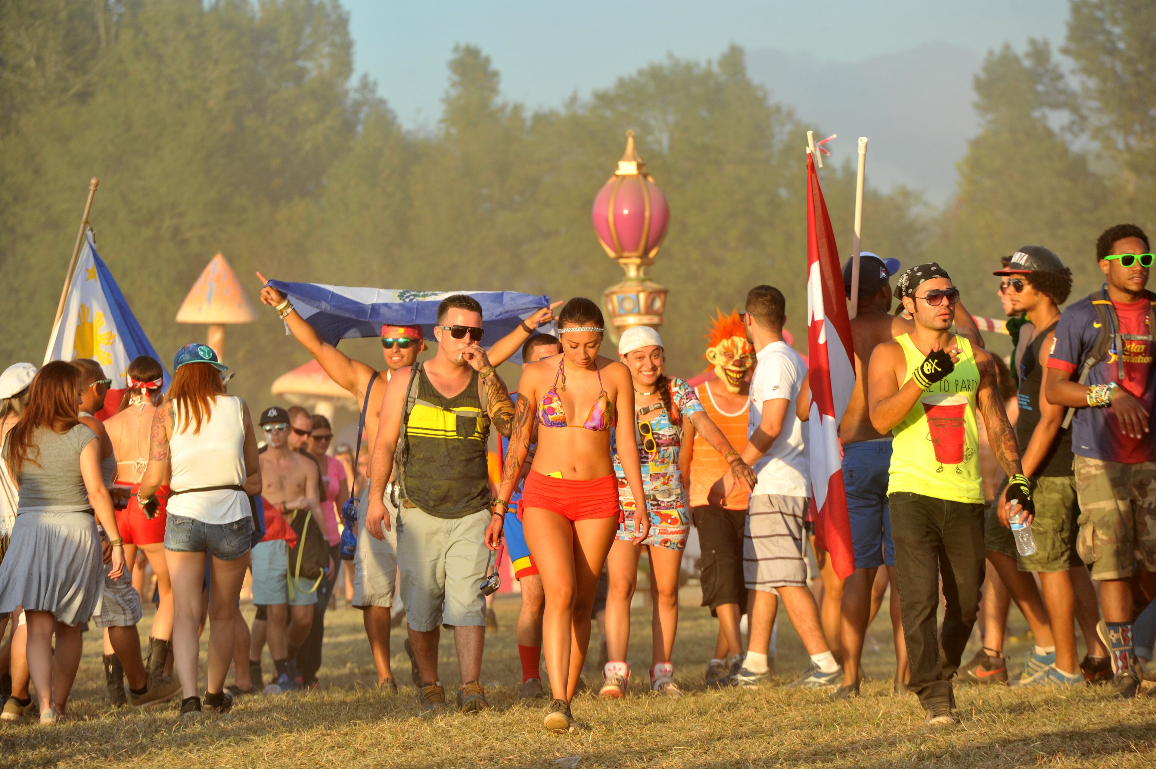 Event-goers walk their way to the mainstage during the TomorrowWorld electronic music festival in Chattahoochee Hills, South of Atlanta, on Saturday, September 27, 2014. It took about three weeks to transform the 350-acres of farm land at Bouckaert Farm in Chattahoochee Hills into the self-contained EDM haven known as TomorrowWorld.The three-day fest officially kicked off at noon Friday and the pulsing bass won't cease until the early hours of Monday morning. HYOSUB SHIN / HSHIN@AJC.COM