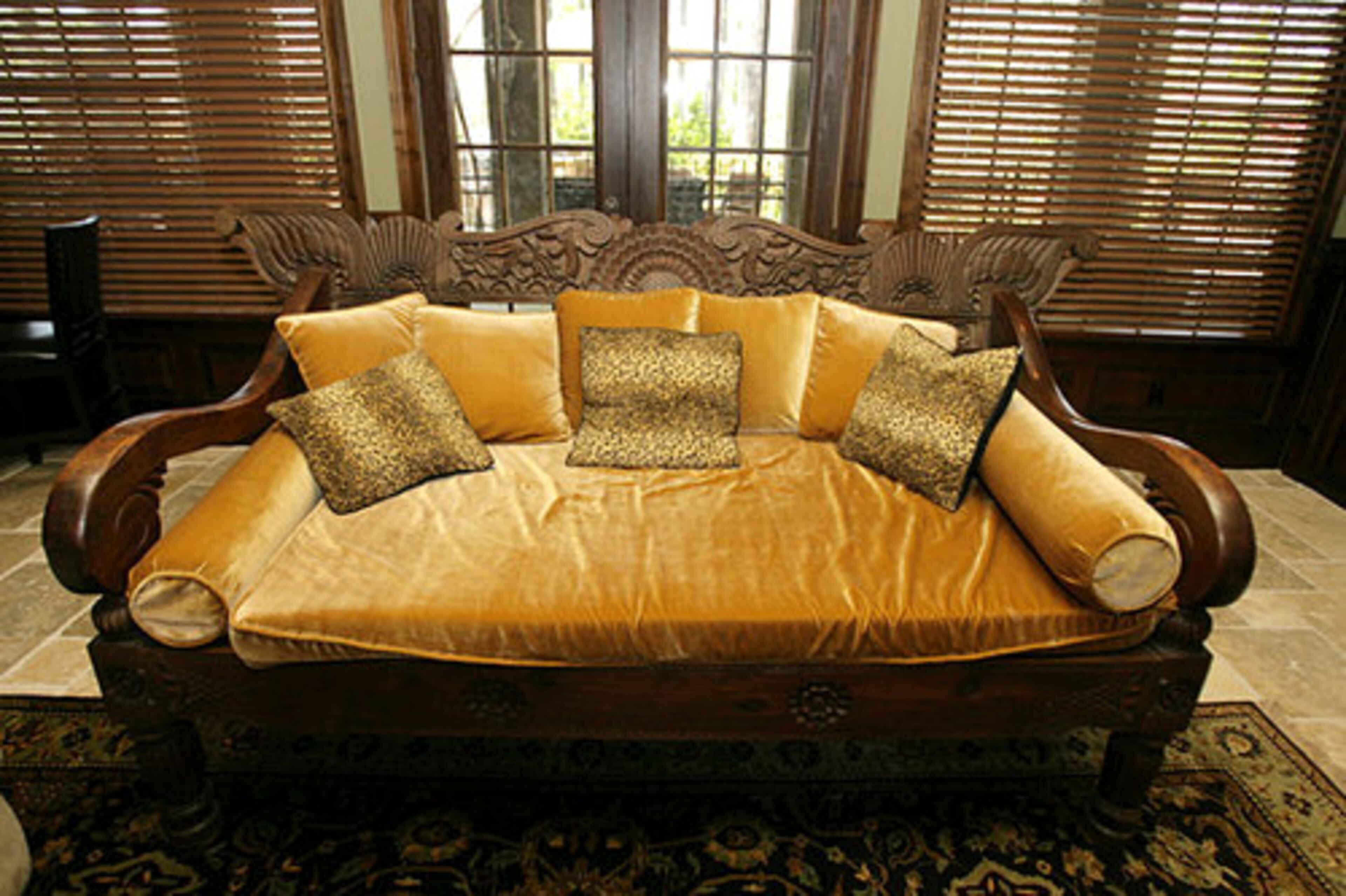 This Thai day bed downstairs is about 120 years old.