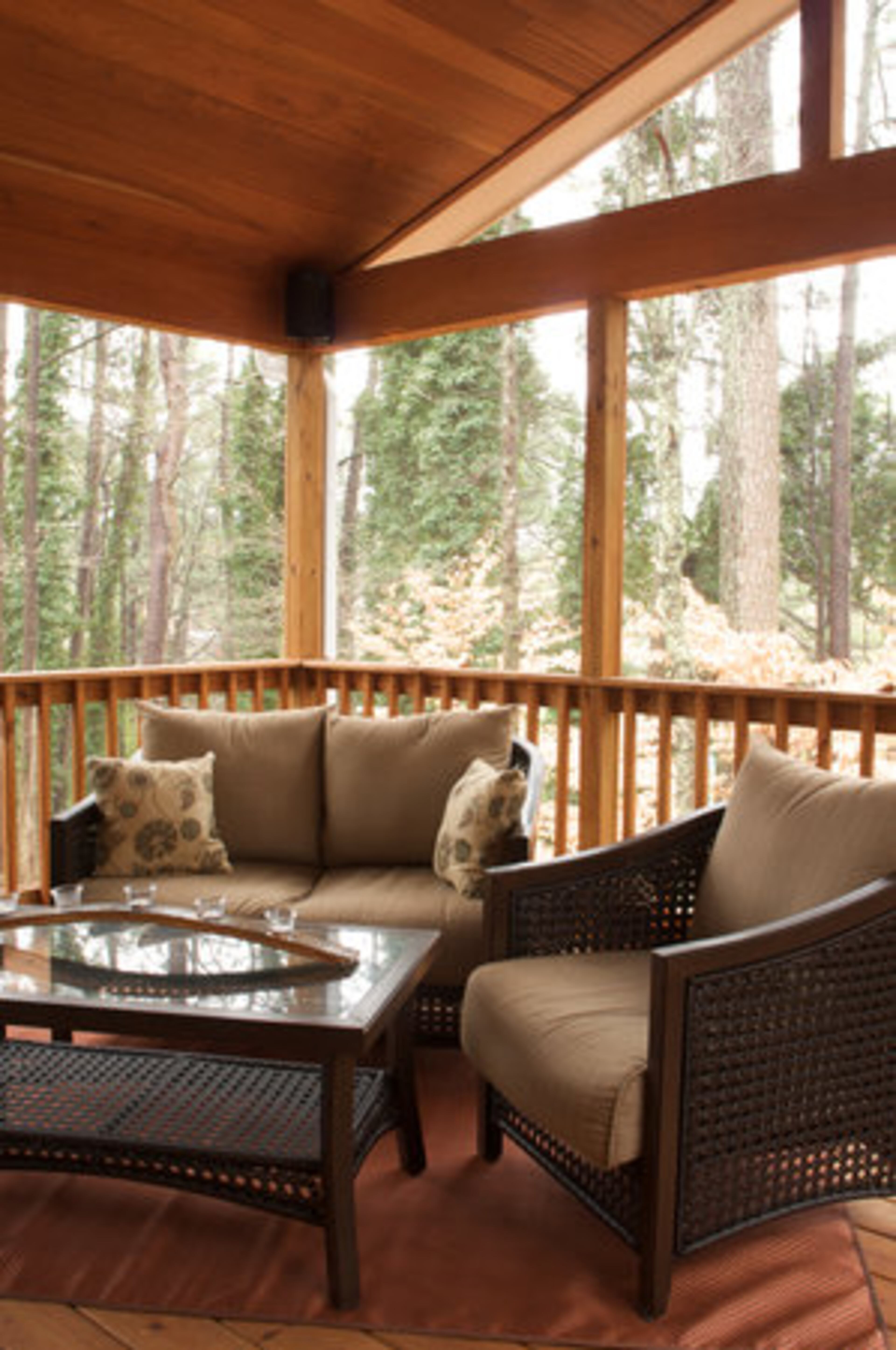 "I'm particularly proud of the screened-in porch we added to expand the living space outdoors and create a seamless flow into the rest of the house for entertaining. We reused the mahogany wood paneling that was removed from the old den and installed it in the ceiling of the new porch," says Jim Walker, owner of Copper Sky Renovations.