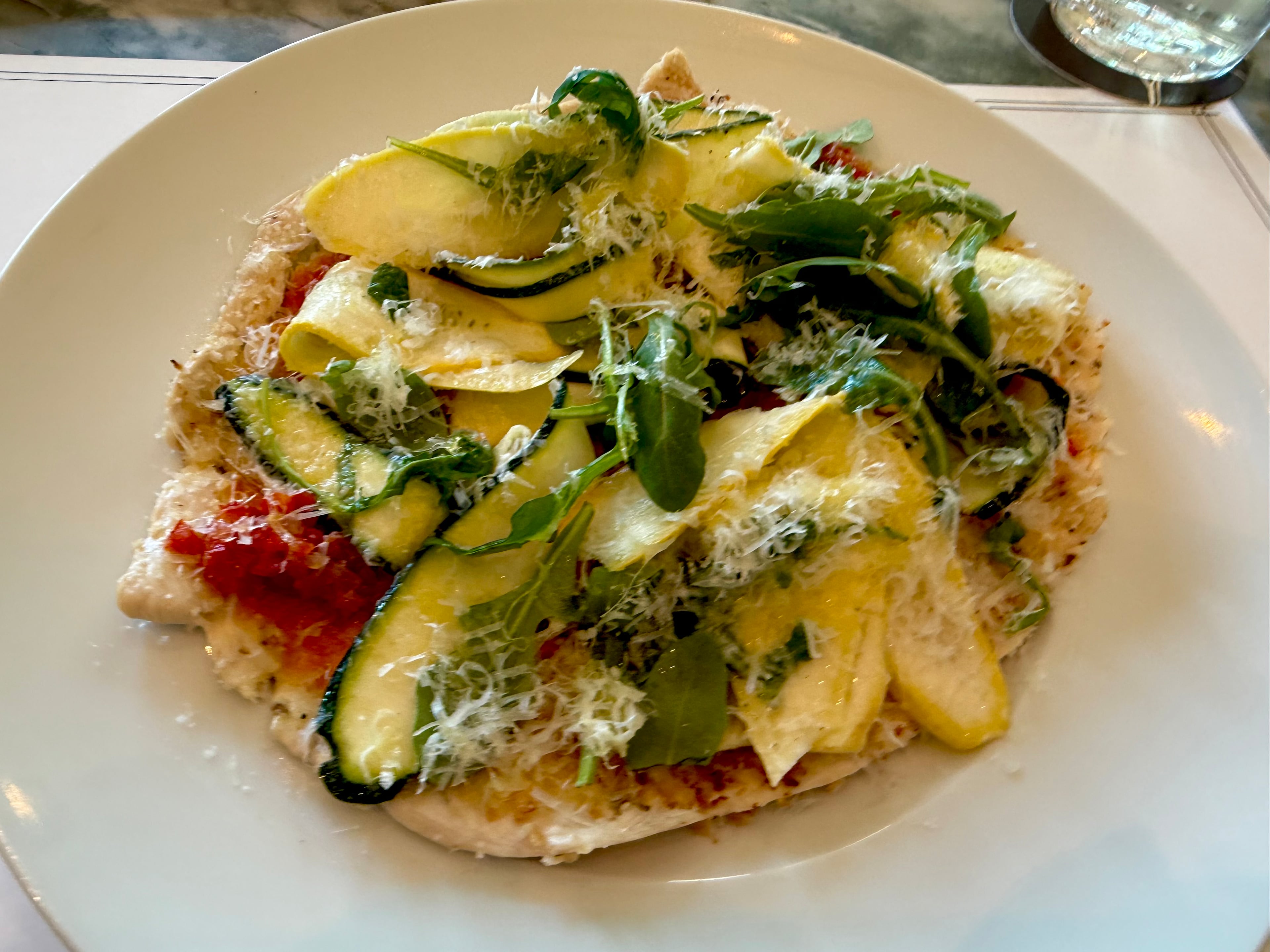 Chicken paillard with squash and zucchini that eats like a flatbread at Sargent in Old Fourth Ward. (Angela Hansberger for the AJC)