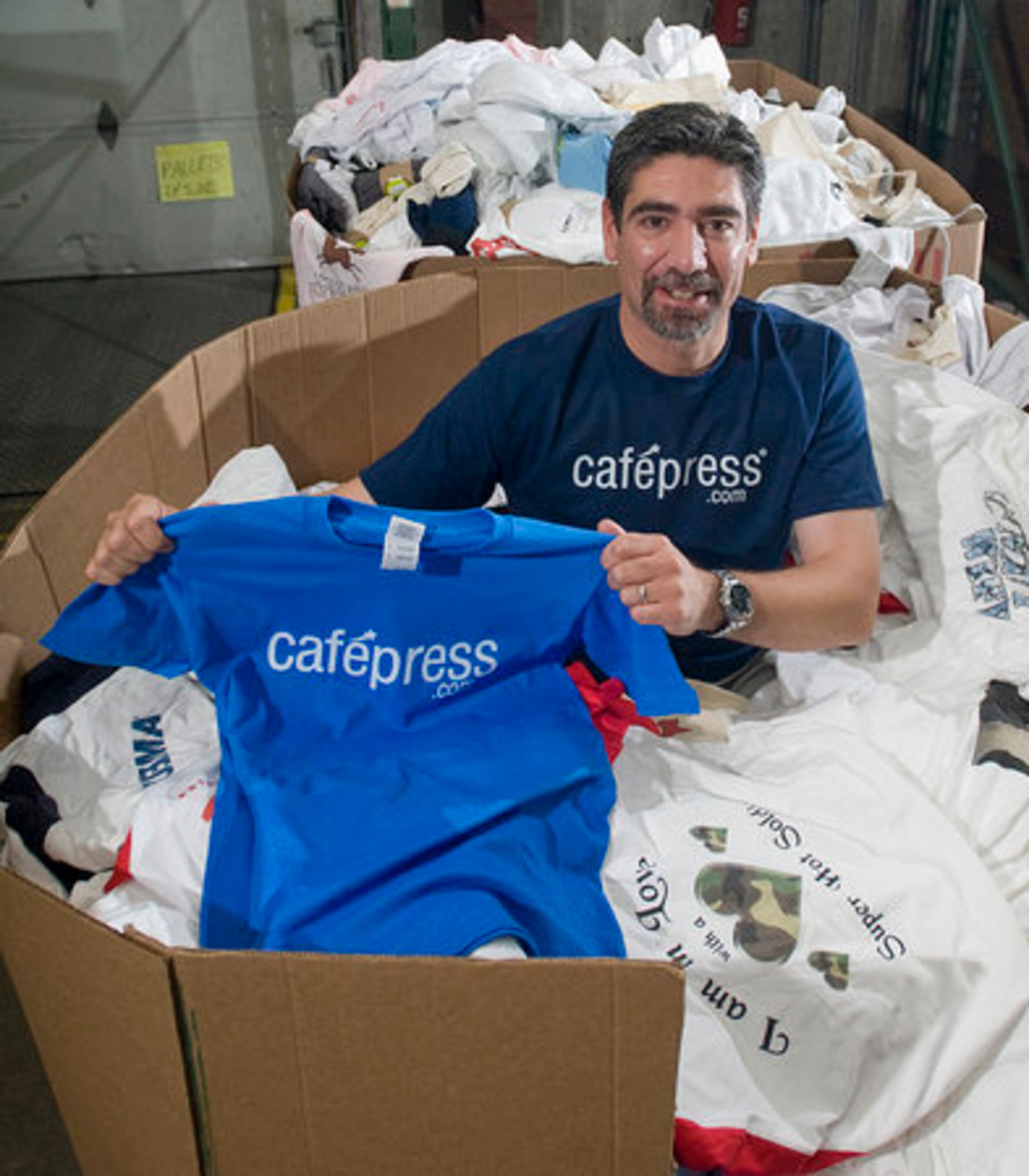 CafePress.Com vice president of operations Bob Marino shows some of the wares the company makes.