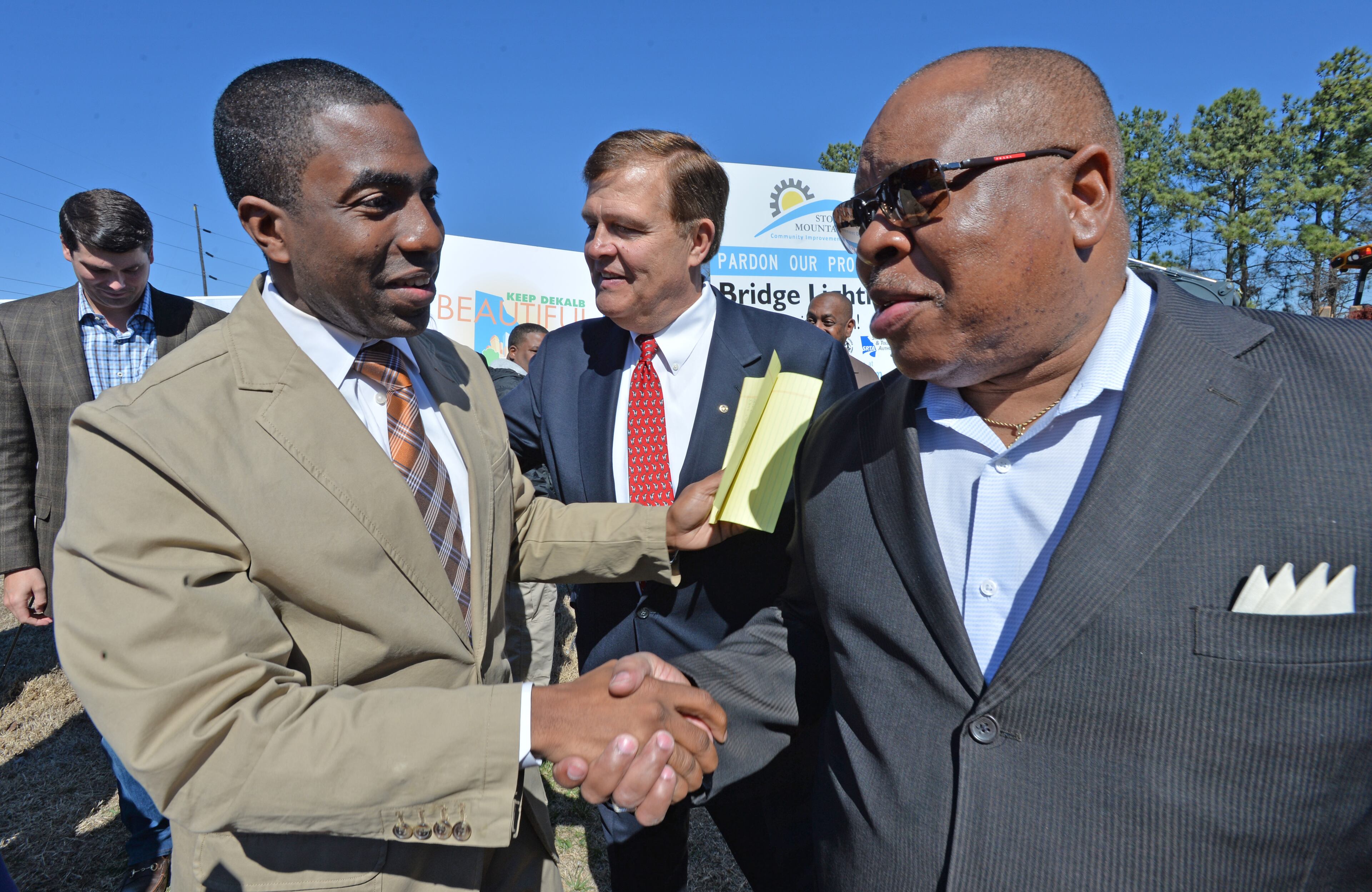 Federal prosecutors linked DeKalb County Commissioner Stan Watson (right, with DeKalb Interim CEO Lee May at left) to defendants in a South Carolina public corruption trial Monday, June 23, 2014, showing jurors Watson’s picture during a witness’ testimony. -- Text by Mark Niesse, AJC