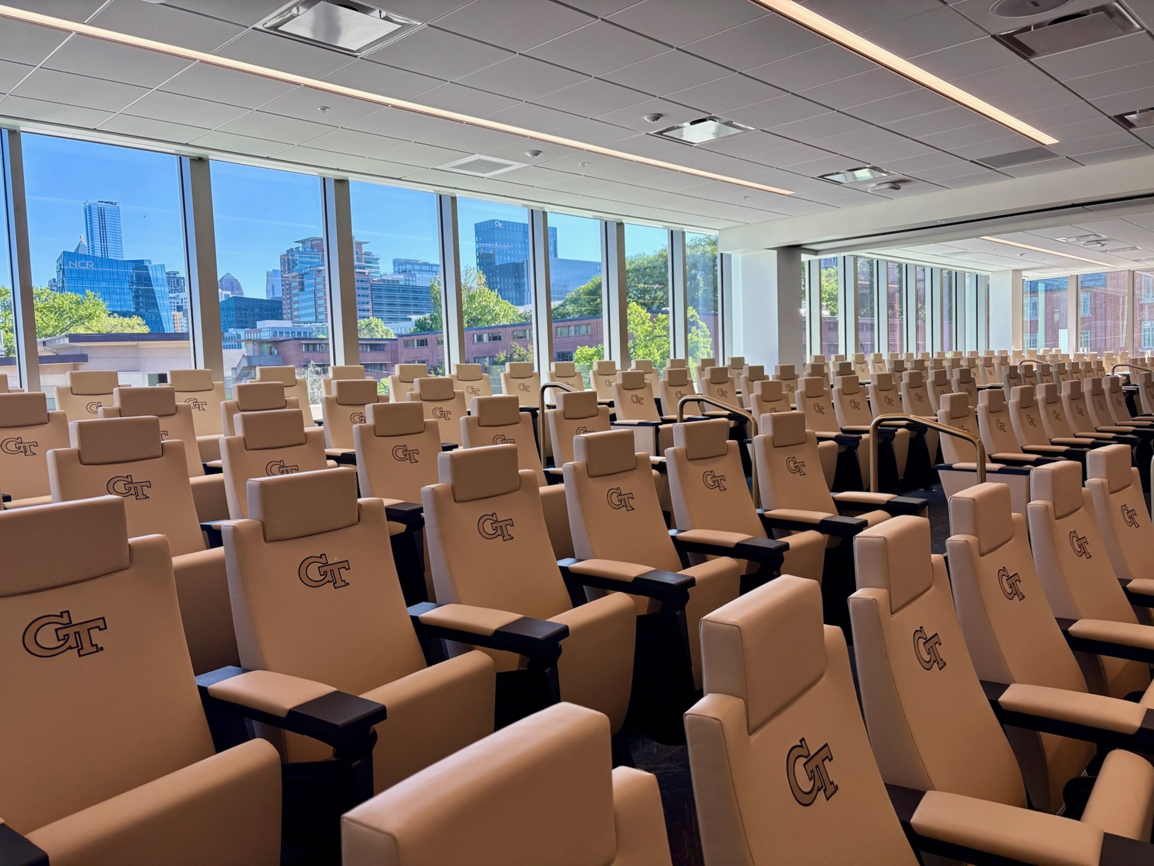 Georgia Tech's football meeting room has seating for 178 and looks out onto Midtown Atlanta's skyline, an element designed to remind team members and show recruits the business opportunities available to Tech graduates. The room can be split into two rooms for offense and defense. (Ken Sugiura/AJC)