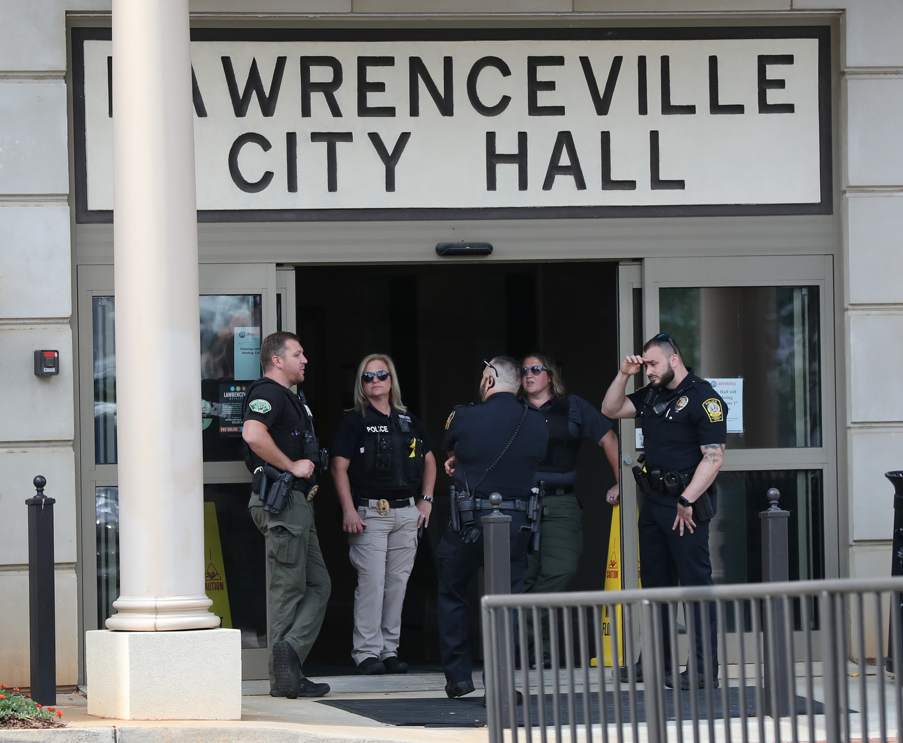060120 Lawrenceville: Law enforcement officials stand at a distance keeping guard while hundreds of protesters gather outside Lawrenceville City Hall as protests continue for a fourth day around metro Atlanta over the death of George Floyd on Monday, June 1, 2020, in Lawrenceville. Curtis Compton ccompton@ajc.com