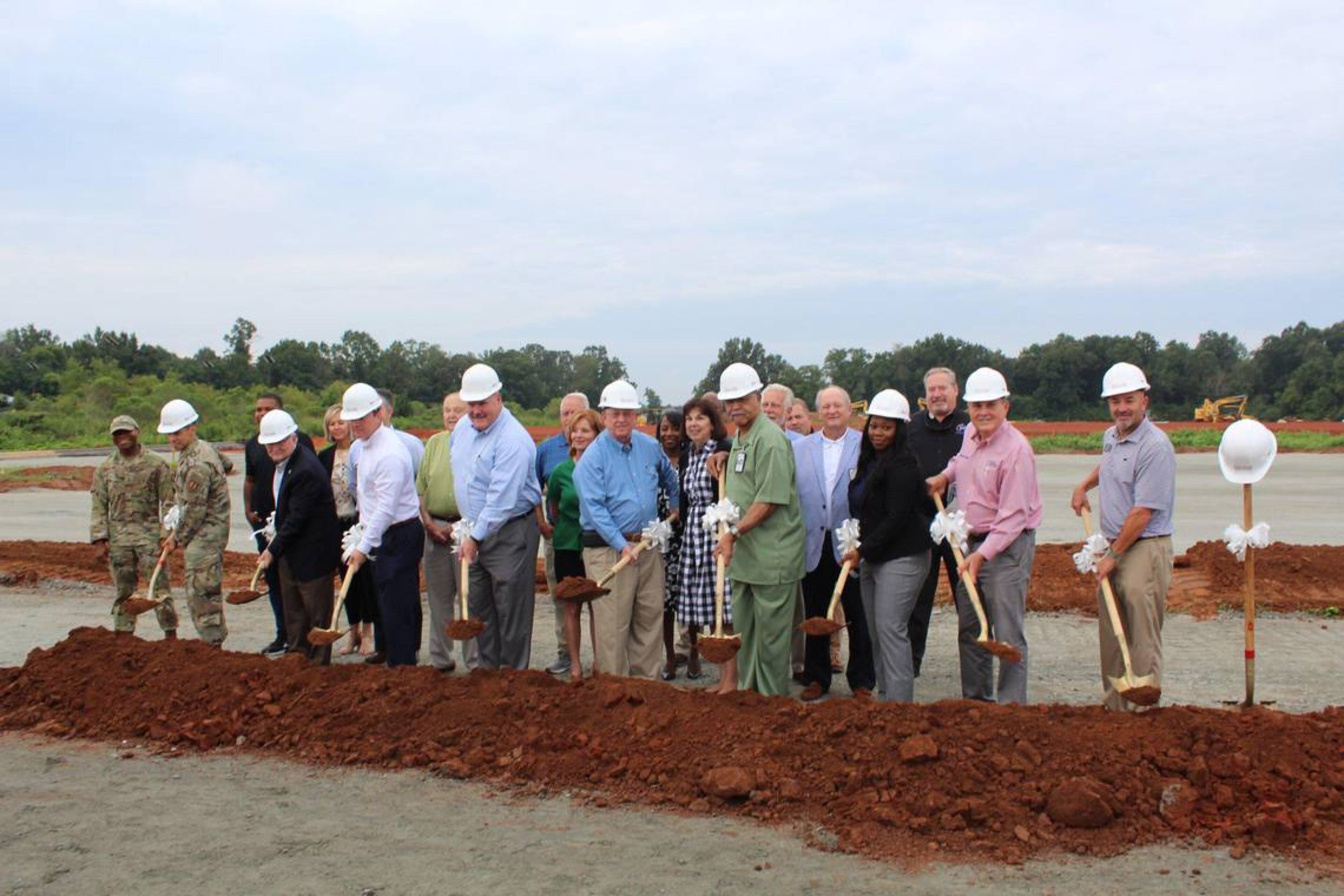 Officials from the Houston County Board of Commissioners, Houston County Board of Education and the city governments of Warner Robins, Perry and Centerville break ground at the construction site. (Courtesy of the Houston County School District)