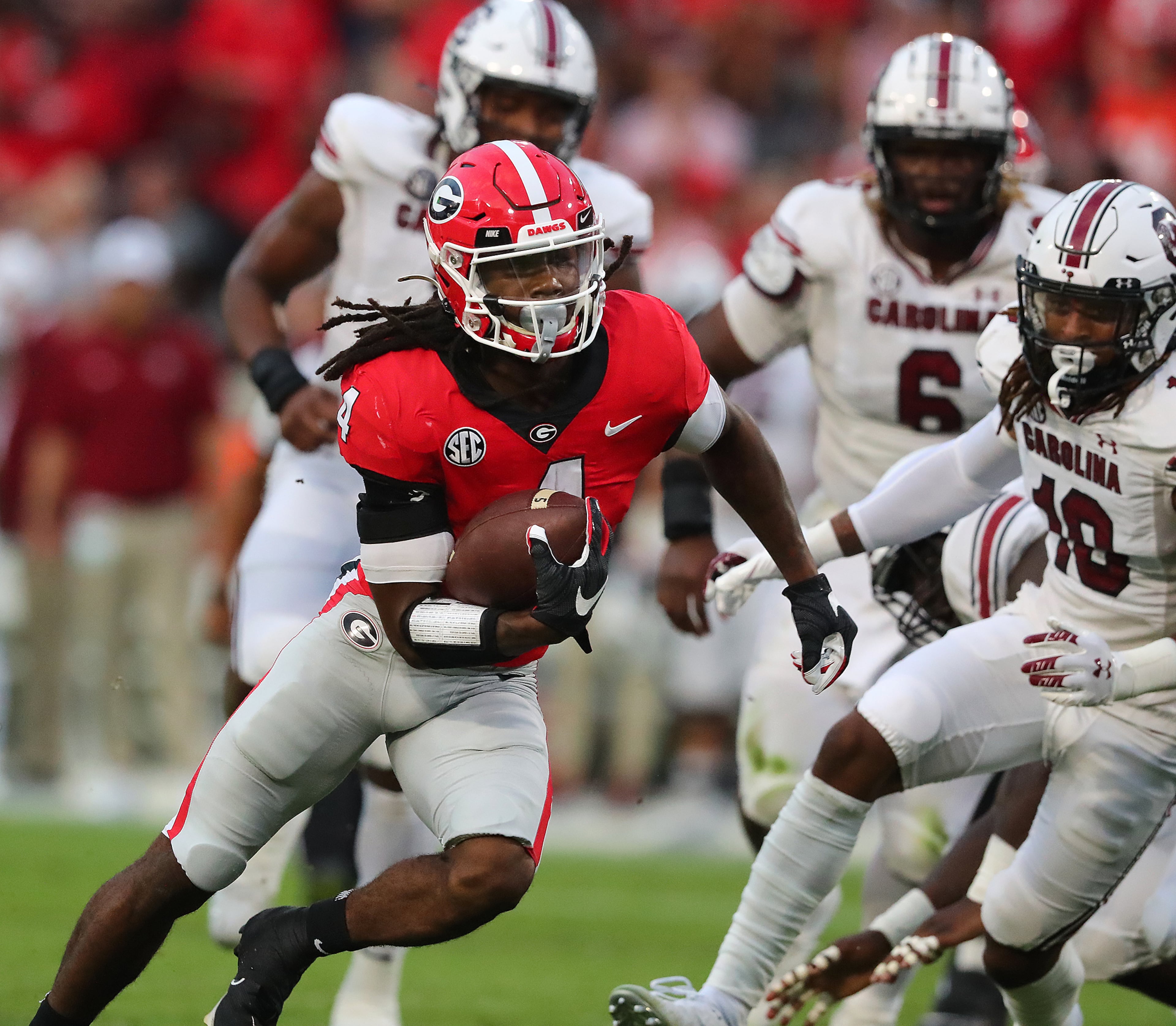 Georgia running back James Cook breaks through South Carolina defenders on a touchdown run to take a 7-0 lead during the first quarter in a NCAA college football game on Saturday, Sept 18, 2021, in Athens. “Curtis Compton / Curtis.Compton@ajc.com”