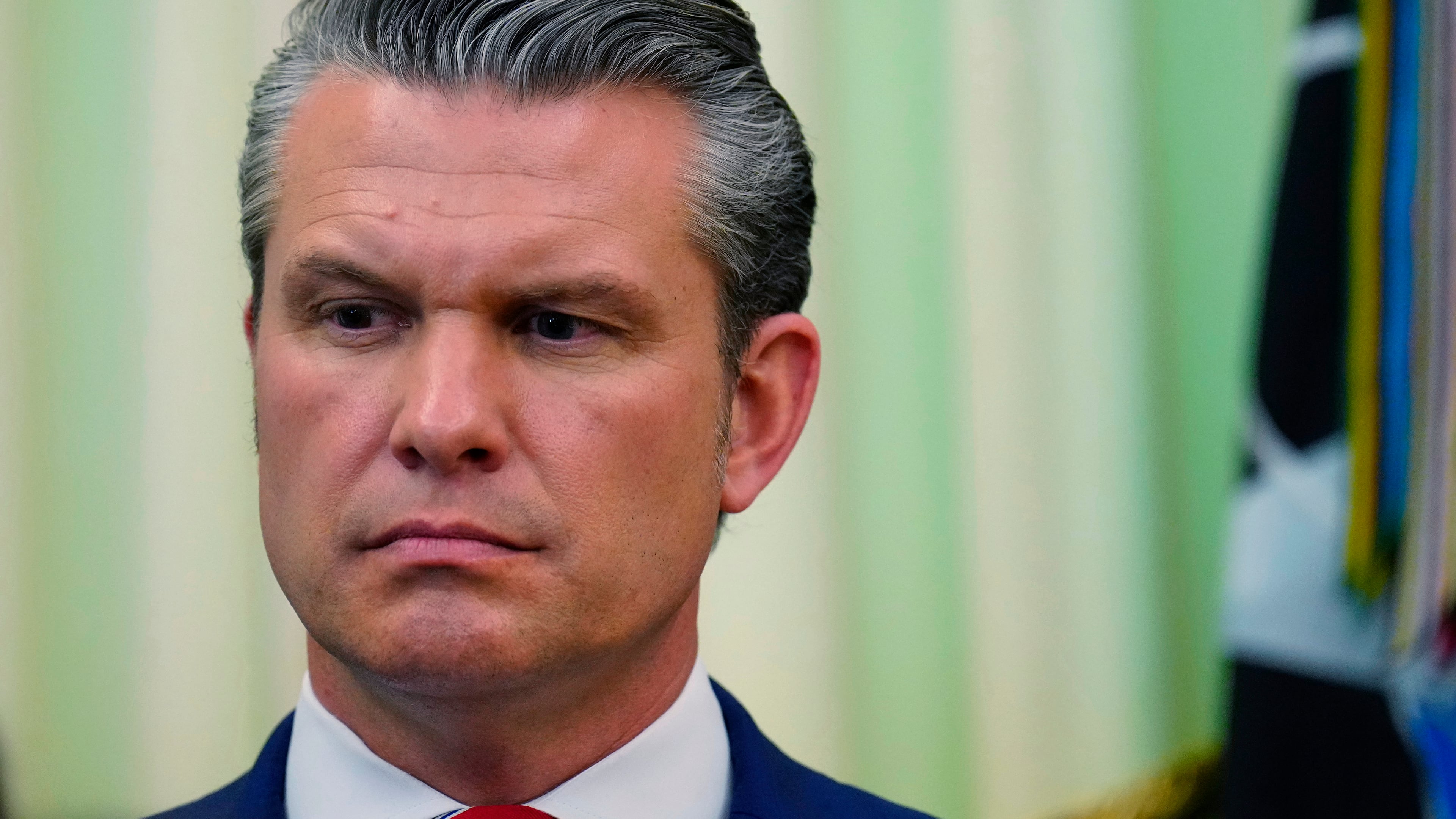 Defense Secretary Pete Hegseth listens as President Donald Trump speaks before signing a proclamation in the Oval Office at the White House, Tuesday, May 5, 2026, in Washington. (AP Photo/Jacquelyn Martin)