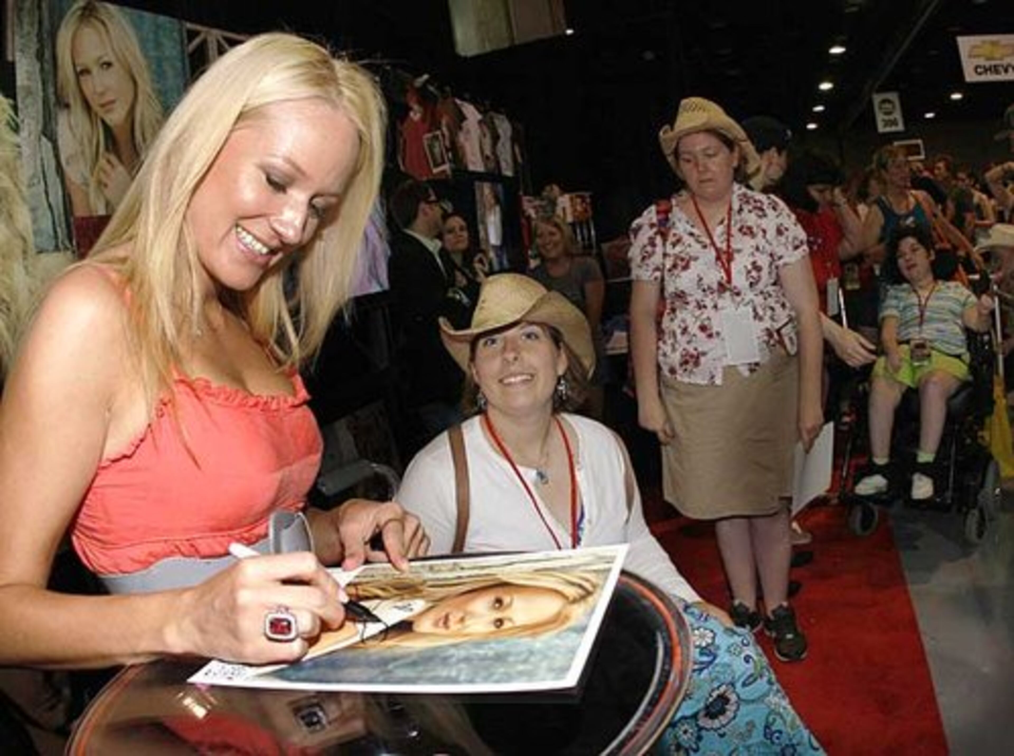 Jewel signs autographs for fans at the CMA Music Festival.