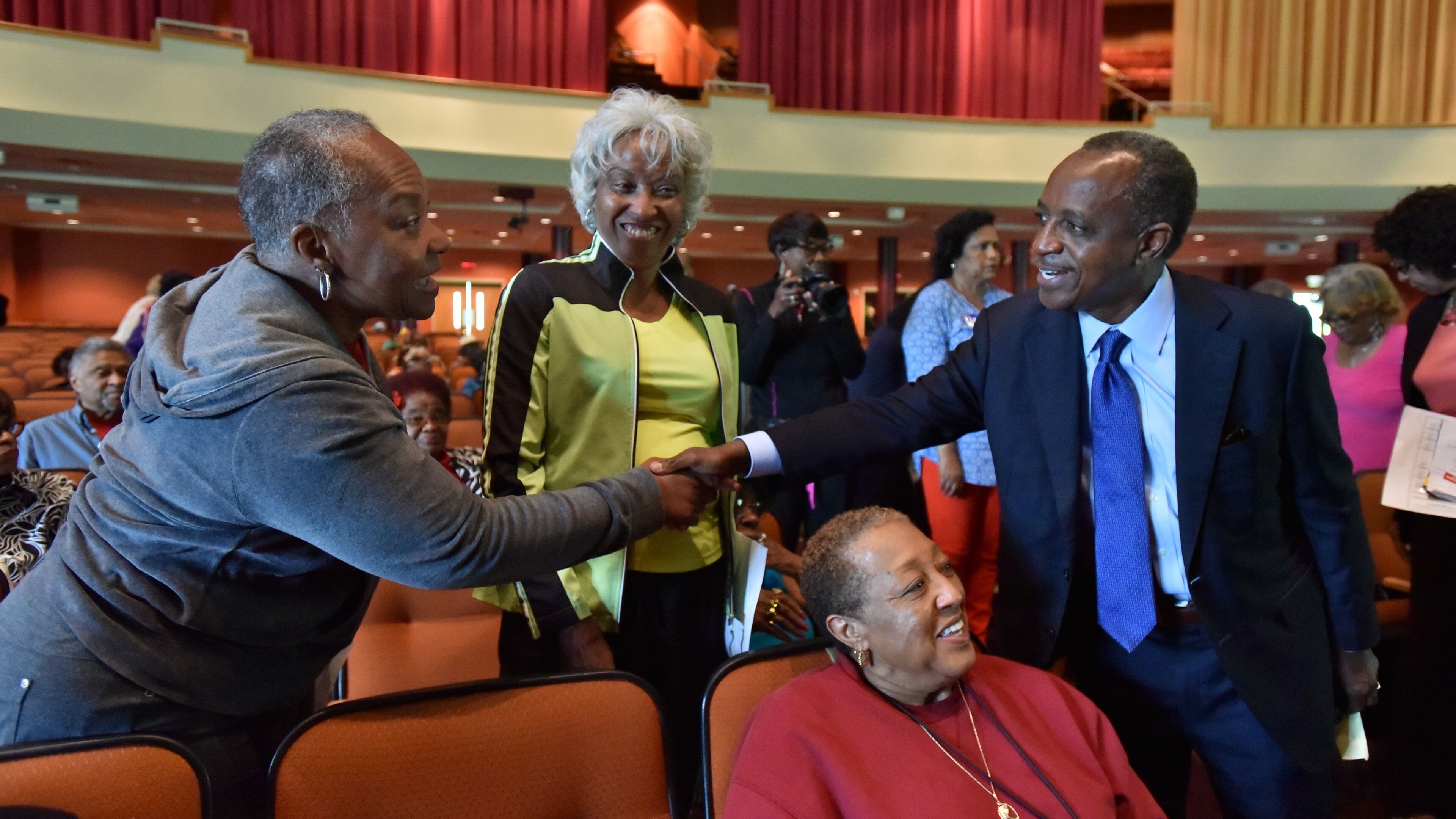 Mike Thurmond, who won the race for DeKalb County CEO on Tuesday, greets seniors Elayn Ansari and Helen Norris during at forum at Salem Bible Church in Lithonia on May 5. HYOSUB SHIN / HSHIN@AJC.COM