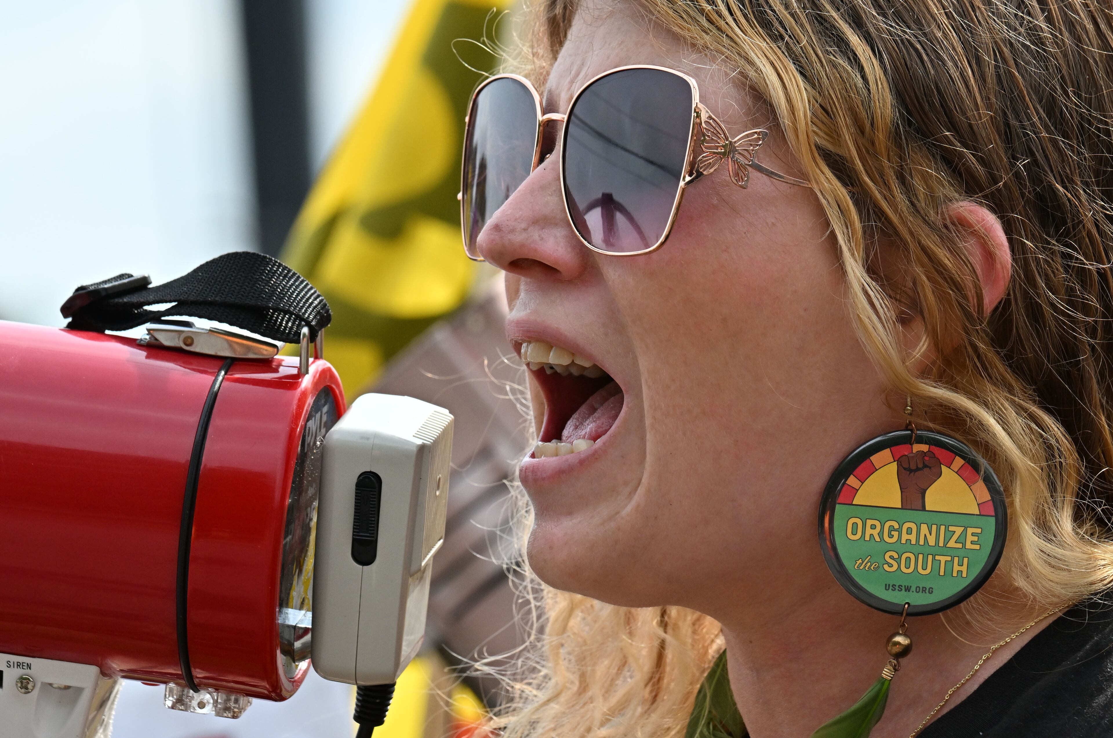 Katie Giede, a Waffle House employee, speaks during a rally in Marietta on Friday. Giede told the crowd that she was stalked by a customer. (Hyosub Shin/AJC)