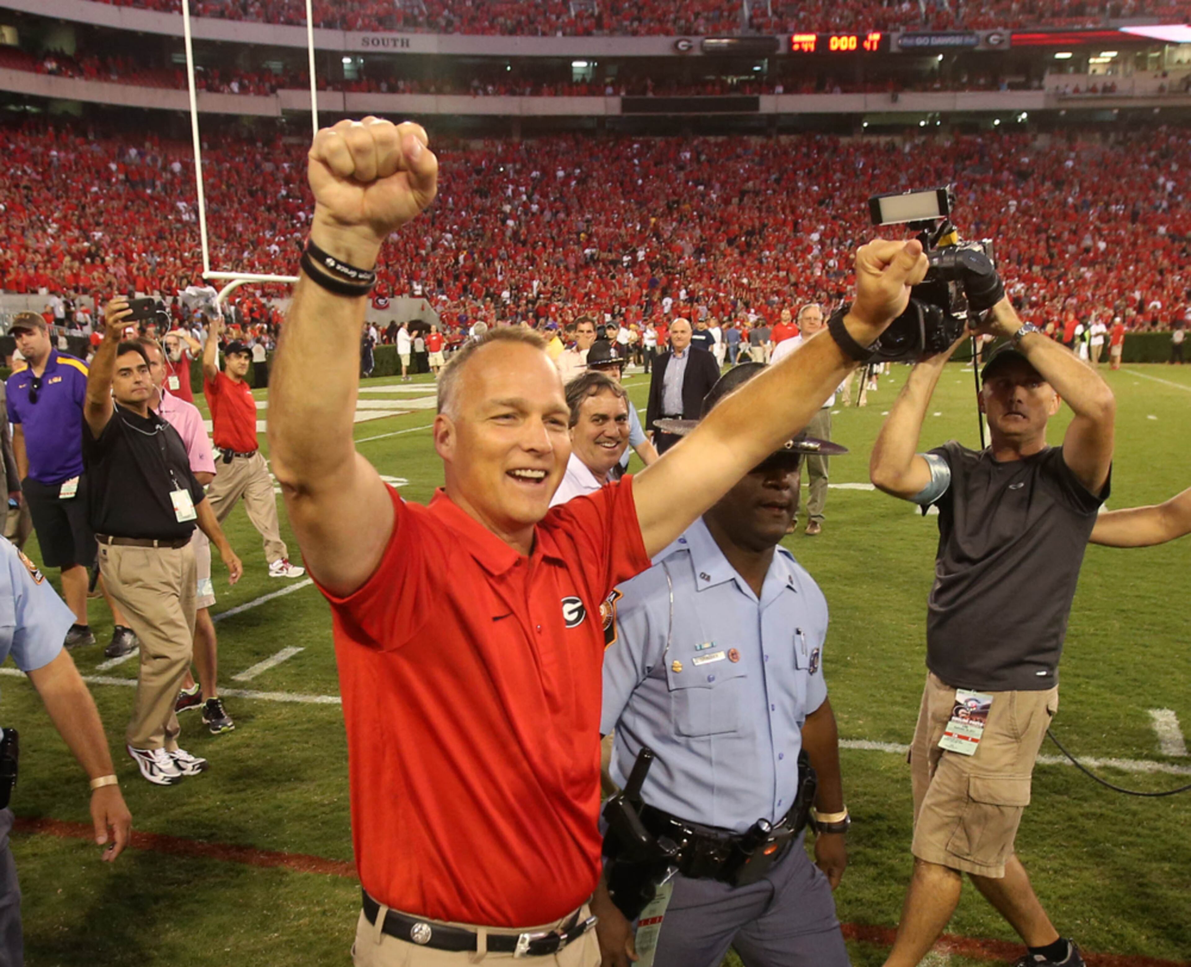 DAWGS WIN--September 28, 2013 - Athens, Ga: University of Georgia coach Mark Richt celebrates with fans after their 44-41 win over Louisiana State University at Sanford Stadium Saturday night in Athens, Ga., September 28, 2013. JASON GETZ / JGETZ@AJC.COM