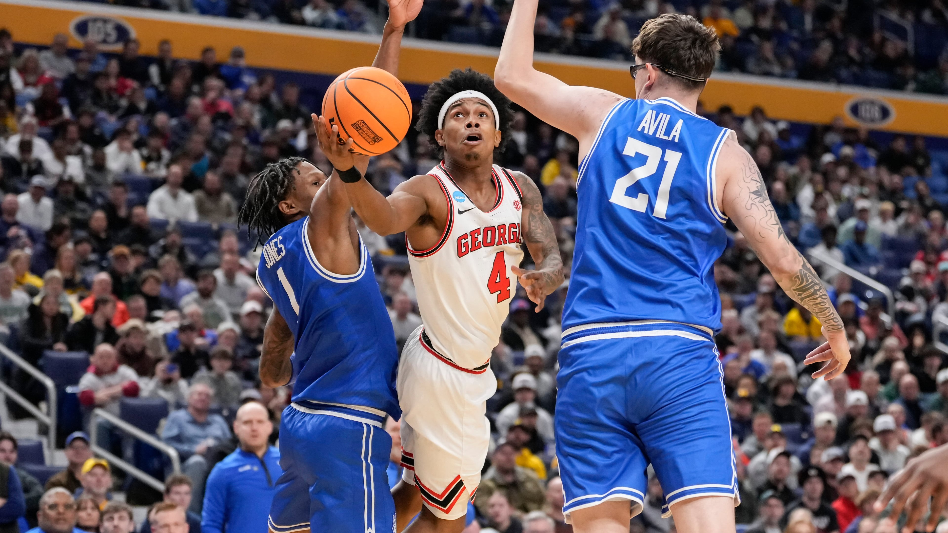 Georgia guard Marcus Millender looks to shoot over Saint Louis center Robbie Avila (right) and guard Quentin Jones (left) during the first half in the first round of the NCAA college basketball tournament Thursday, March 19, 2026, in Buffalo, N.Y. (Yuki Iwamura/AP)