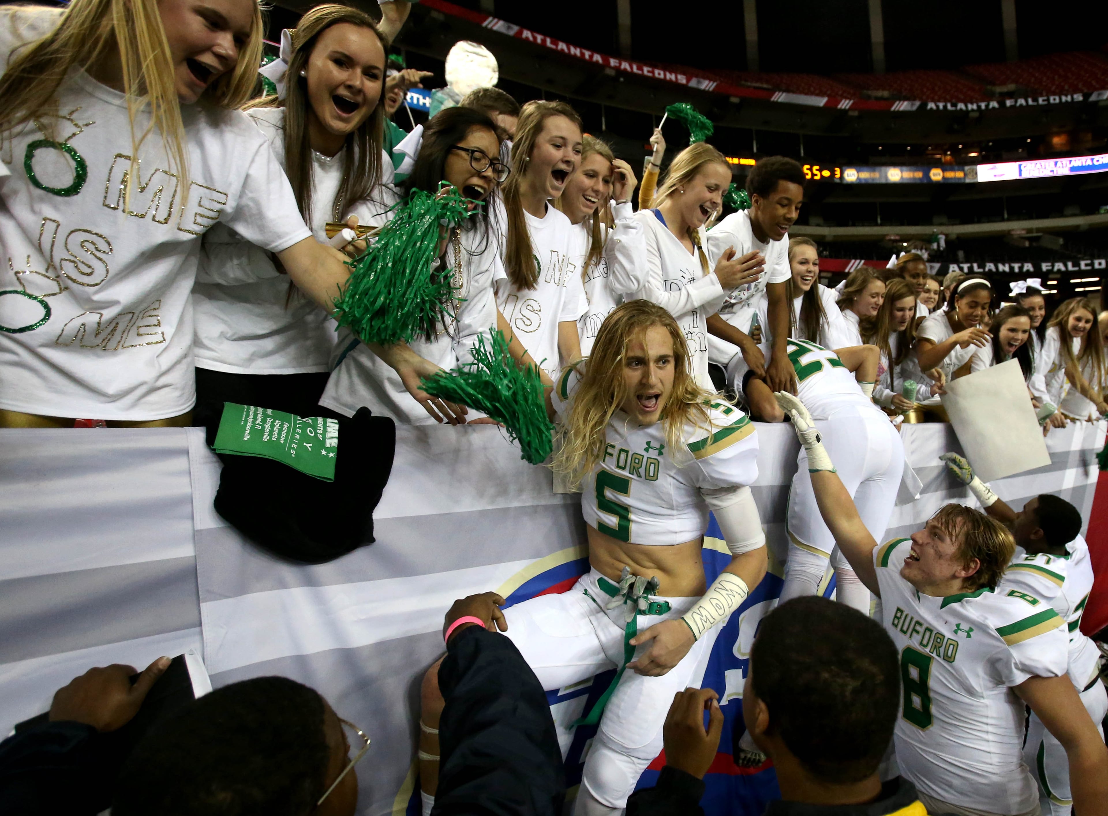 Buford defensive back Steven Reese (5) celebrates with fans after Buford's win over St. Pius in the Class AAAA state high school football championship at the Georgia Dome Saturday in Atlanta, Ga., December 13, 2014. Buford won 55-10.
