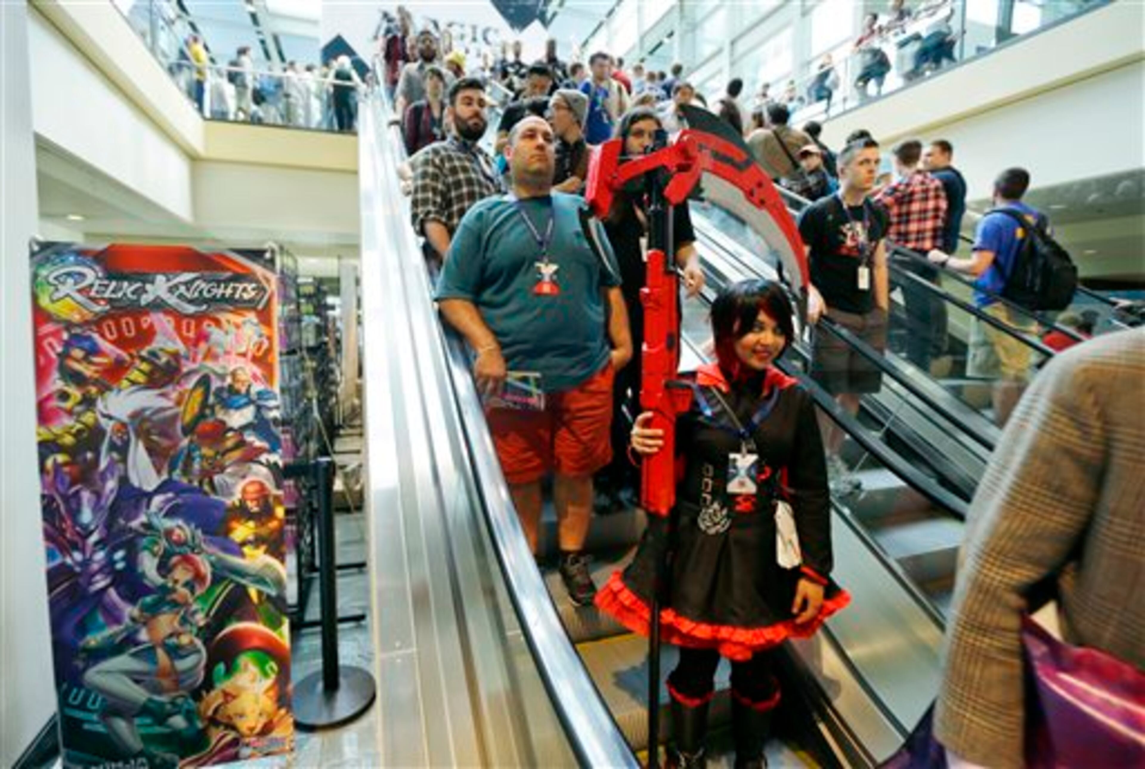 A costumed attendee rides an escalator Friday, Aug. 29, 2014, at the Penny Arcade Expo, a fan-centric celebration of gaming in Seattle. The event is expected to be attended by roughly 85,000 gamers and will include concerts, game tournaments and previews of upcoming titles. (AP Photo/Ted S. Warren)