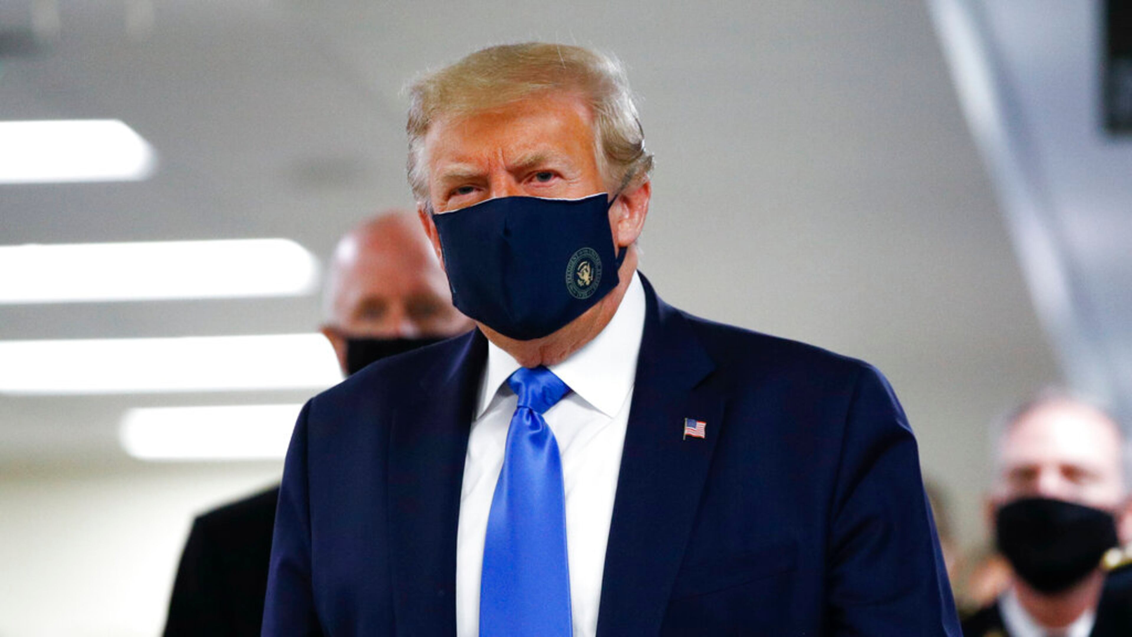 President Donald Trump wears a mask as he walks down the hallway during his visit to Walter Reed National Military Medical Center in Bethesda, Md., Saturday, July 11, 2020. (AP Photo/Patrick Semansky)