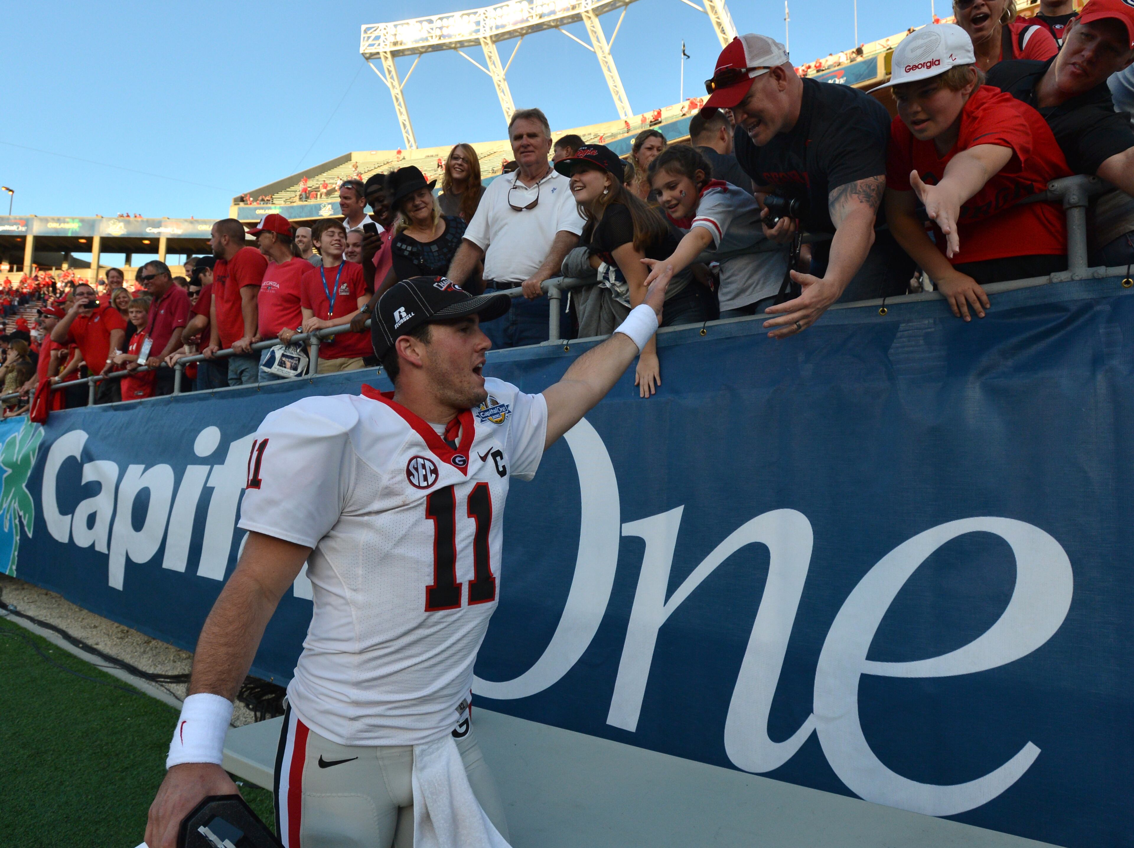January 1, 2013 Orlando, FL: Georgia quarterback Aaron Murray celebrates his team's win against Nebraska in the Capital One Bowl in Orlando Tuesday January 1, 2013. The victory was Murray's first first bowl game win. Murray was also named MVP. BRANT SANDERLIN / BSANDERLIN@AJC.COM
